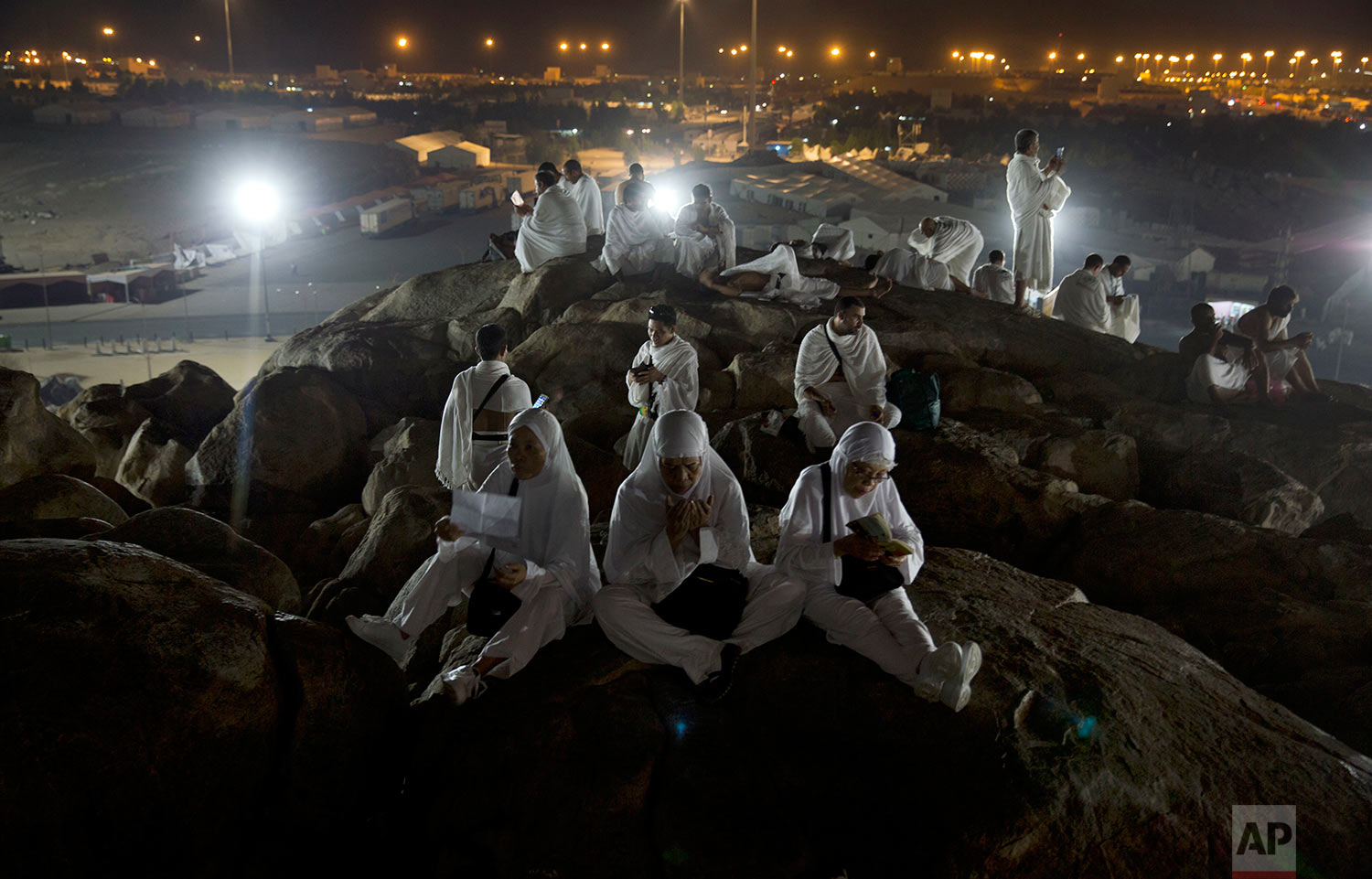  Muslim pilgrims pray on top of the Jabal Al Rahma holy mountain, or the mountain of forgiveness, upon their arrival to Arafat for the annual hajj pilgrimage, outside the holy city of Mecca, Saudi Arabia, Wednesday, Aug. 30, 2017. (AP Photo/Khalil Ha