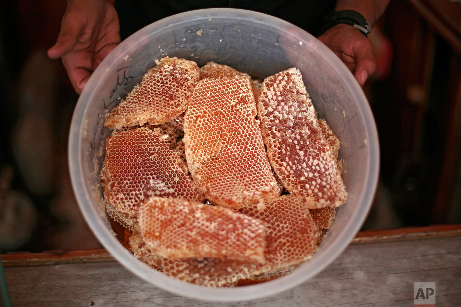  A Yemeni vendor displays honeycomb for sale in a shop in Sanaa, Yemen on Aug. 22, 2017. Yemen’s ruinous civil war has claimed an unlikely victim: The country’s prized honey industry. Thick, rich and as dense as liquid gold, Yemen’s honey has traditi