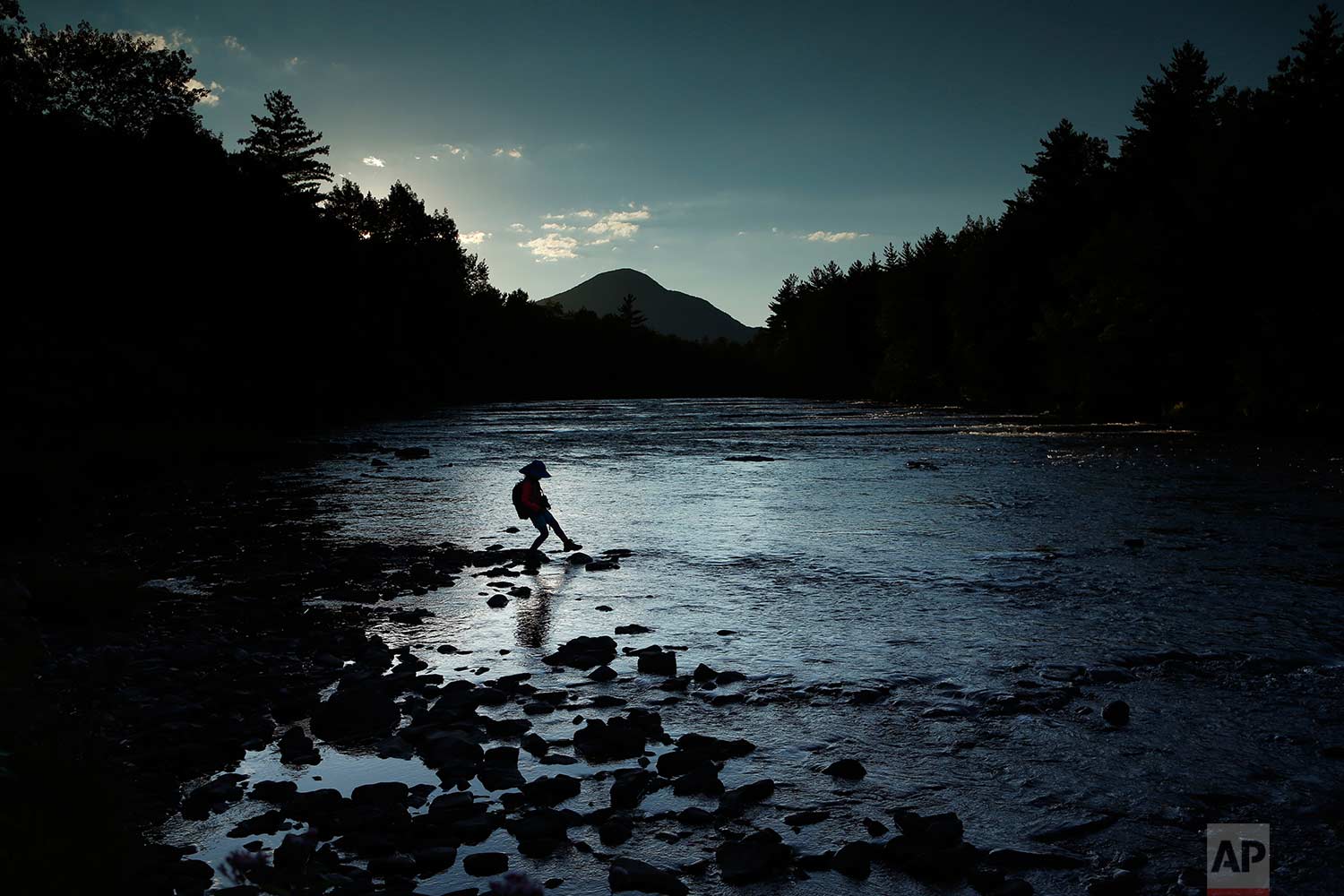  In this Tuesday, Aug. 8, 2017 photo, a youngster explores the Penobscot River's East Branch at the new Katahdin Woods and Waters National Monument near Patten, Maine. Interior Secretary Ryan Zinke wants to retain the newly created national monument,