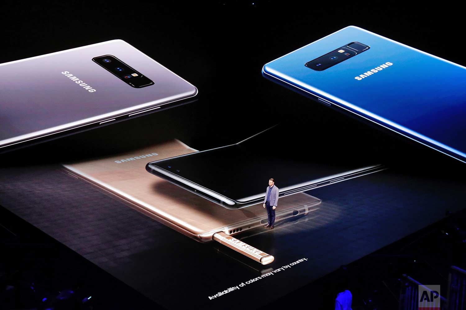  Justin Denison, vice president of strategy for Samsung Telecommunications America, stands among projections of the company's Galaxy Note 8, during the phone's introduction, in New York, Wednesday, Aug. 23, 2017. (AP Photo/Richard Drew) 