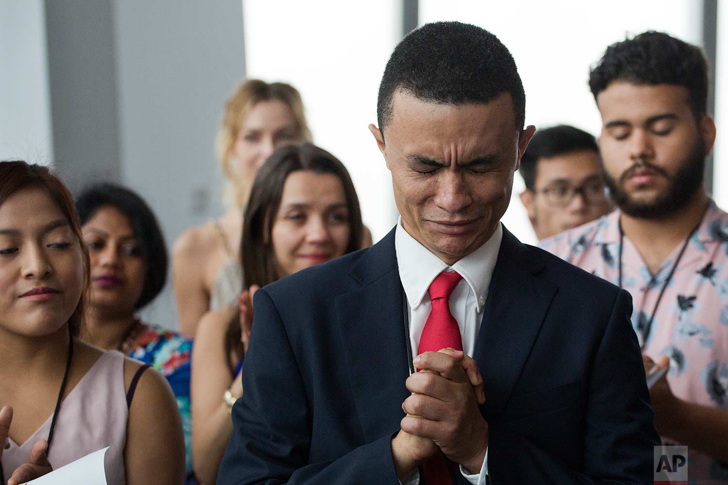 Gleidson Hoffman, originally from Brazil, becomes emotional during his naturalization ceremony, Tuesday, Aug. 15, 2017, in New York. (AP Photo/Mark Lennihan) 