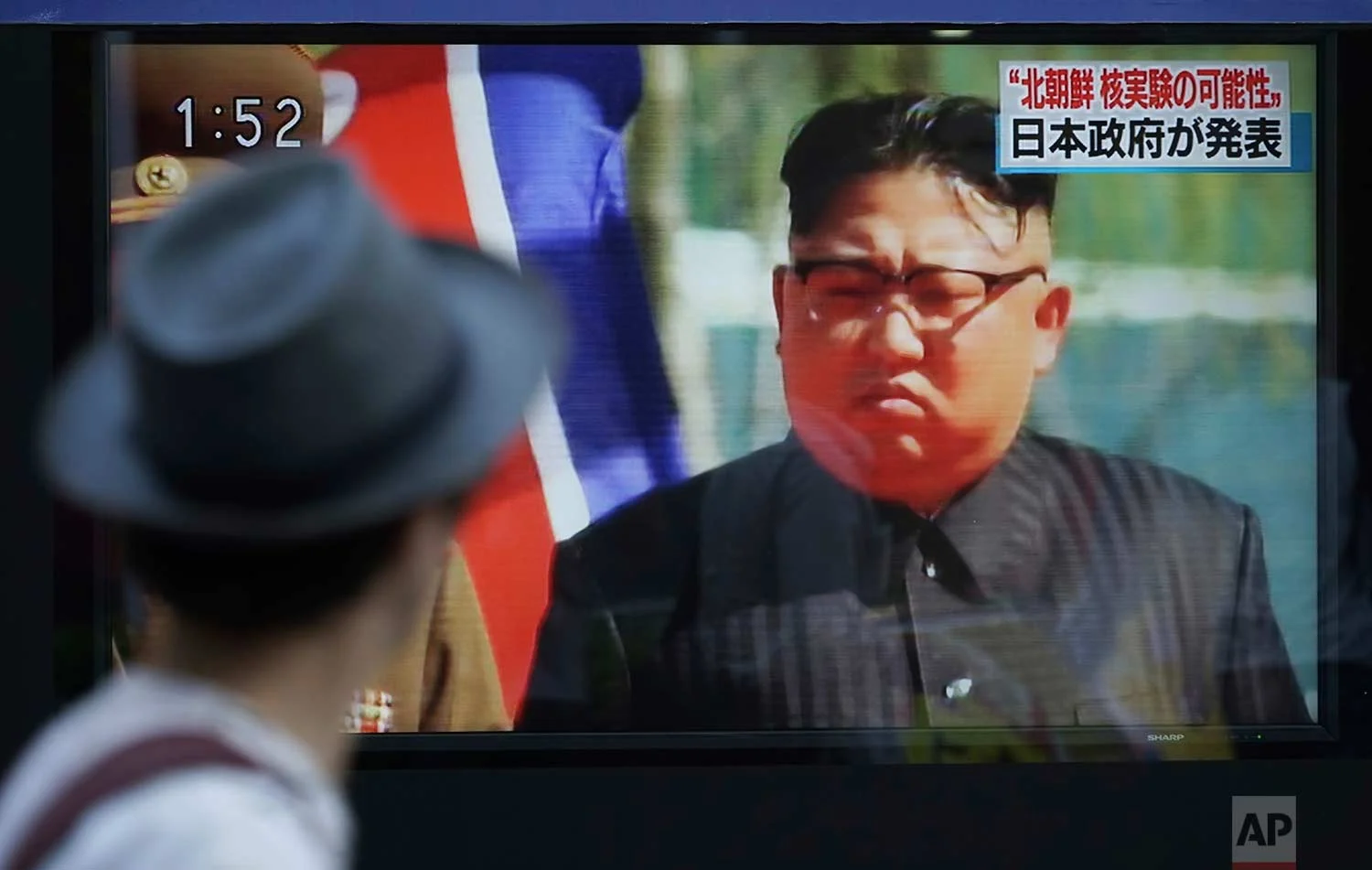A man watches a TV news program on a public screen showing an image of North Korean leader Kim Jong Un while reporting North Korea's possible nuclear test in Tokyo Sunday, Sept. 3, 2017. South Korea's military said Sunday that North Korea is believed to have conducted its sixth nuclear test after it detected a strong earthquake, hours after Pyongyang claimed that its leader has inspected a hydrogen bomb meant for a new intercontinental ballistic missile. (AP Photo/Eugene Hoshiko)
