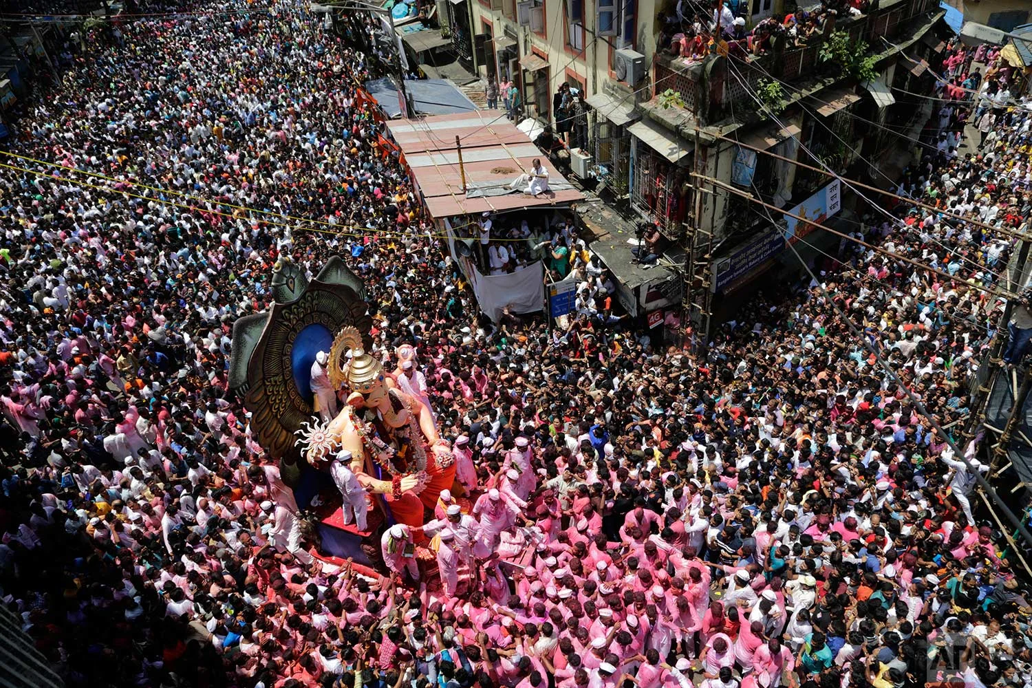 A crowd of Hindu devotees participate in a procession towards the Arabian Sea with a giant idol of the elephant-headed god Ganesha to immerse it on the final day of the ten-day long Ganesha Chaturthi festival in Mumbai, India, Tuesday, Sept. 5, 2017. (AP Photo/Rajanish Kakade)