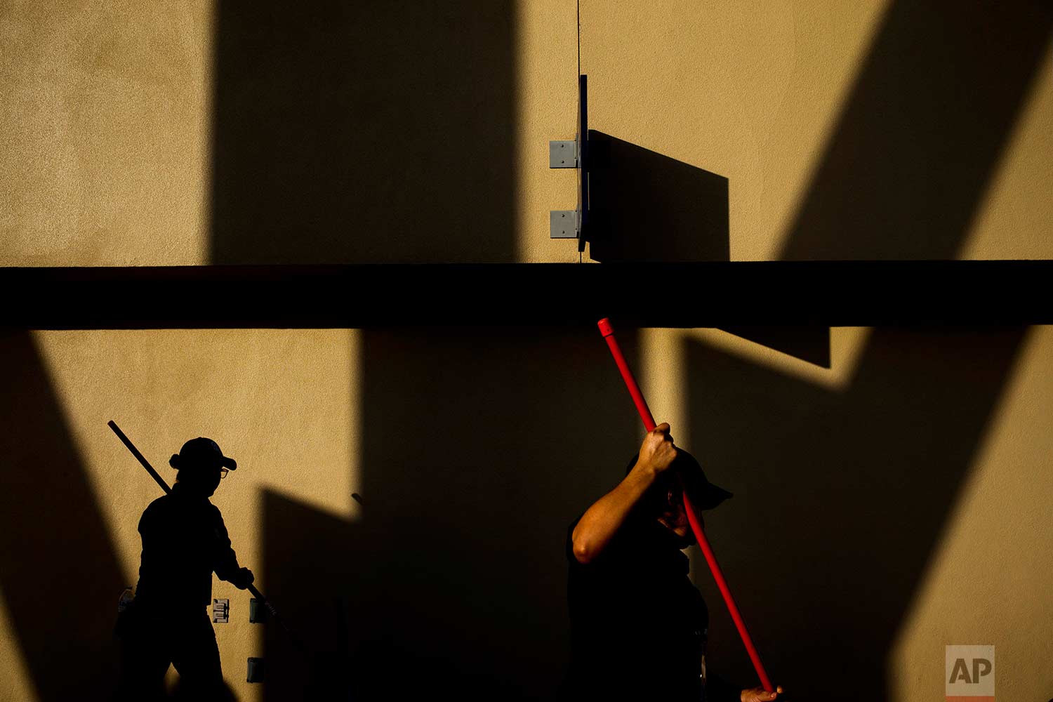  Workers clean the floor at Petco Park before a baseball game between the San Diego Padres and the Los Angeles Dodgers, Saturday, Sept. 2, 2017, in San Diego. (AP Photo/Jae C. Hong) 