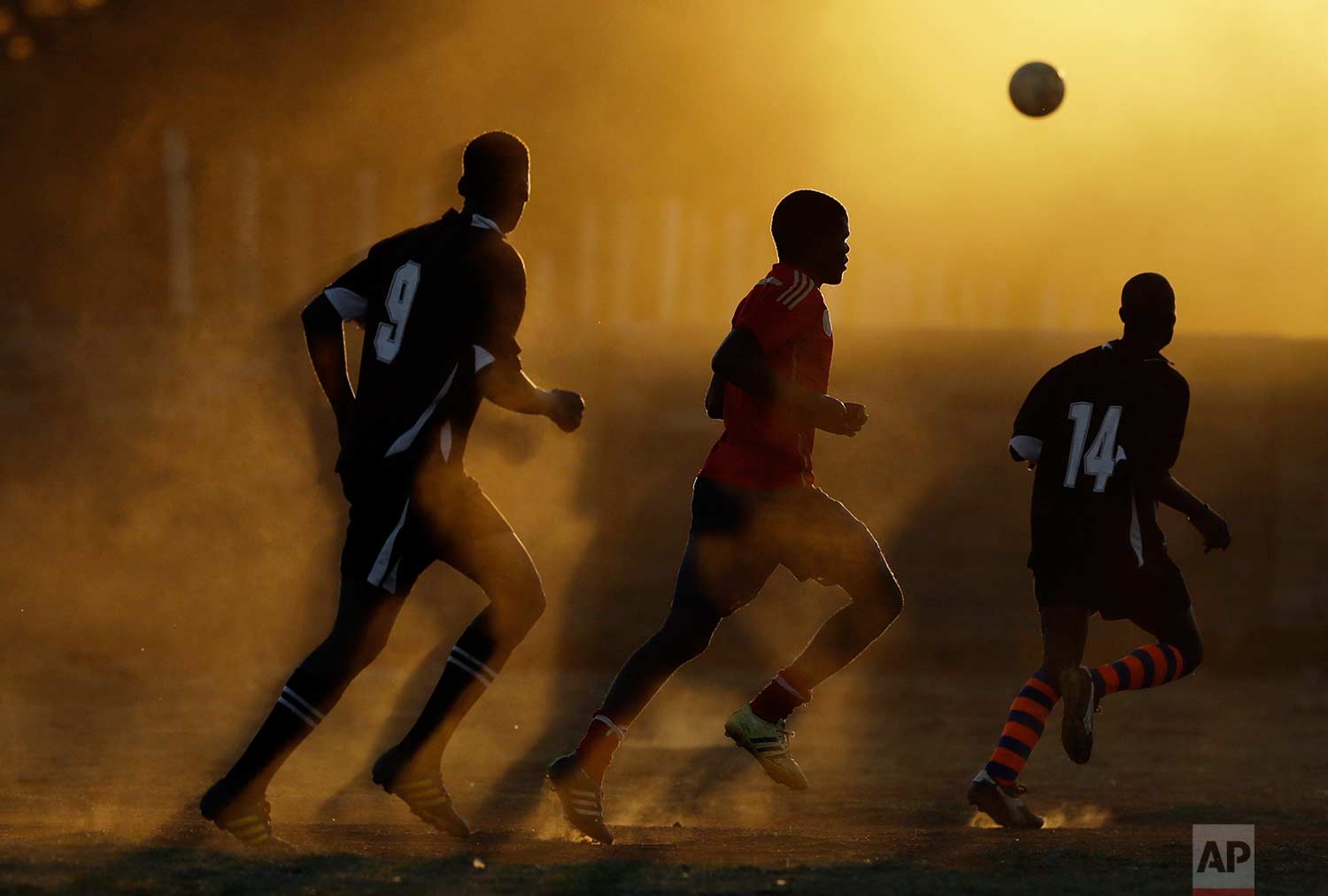  Players chase the ball on a dusty field during their soccer match in Nigel, east of Johannesburg, South Africa, Sunday, Sept. 3, 2017. (AP Photo/Themba Hadebe) 