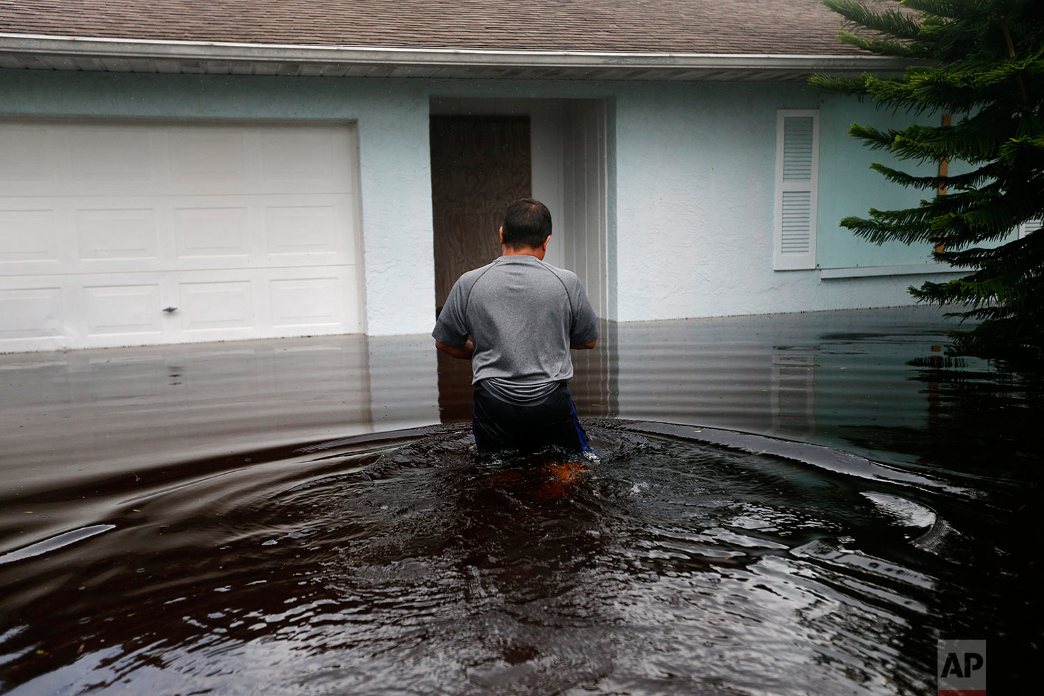  A man returns to his flooded home in the aftermath of Hurricane Irma in Bonita Springs, Fla., Monday, Sept. 11, 2017. (AP Photo/Gerald Herbert) 