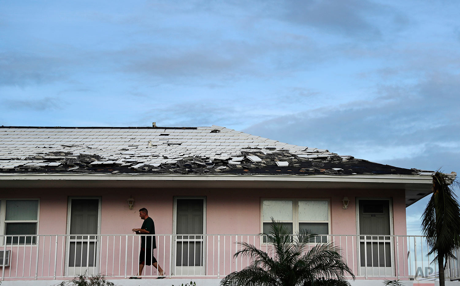  Tony Loduca walks back to his apartment past a roof whose tiles where torn off from Hurricane Irma in Marco Island, Fla., Monday, Sept. 11, 2017. (AP Photo/David Goldman) 