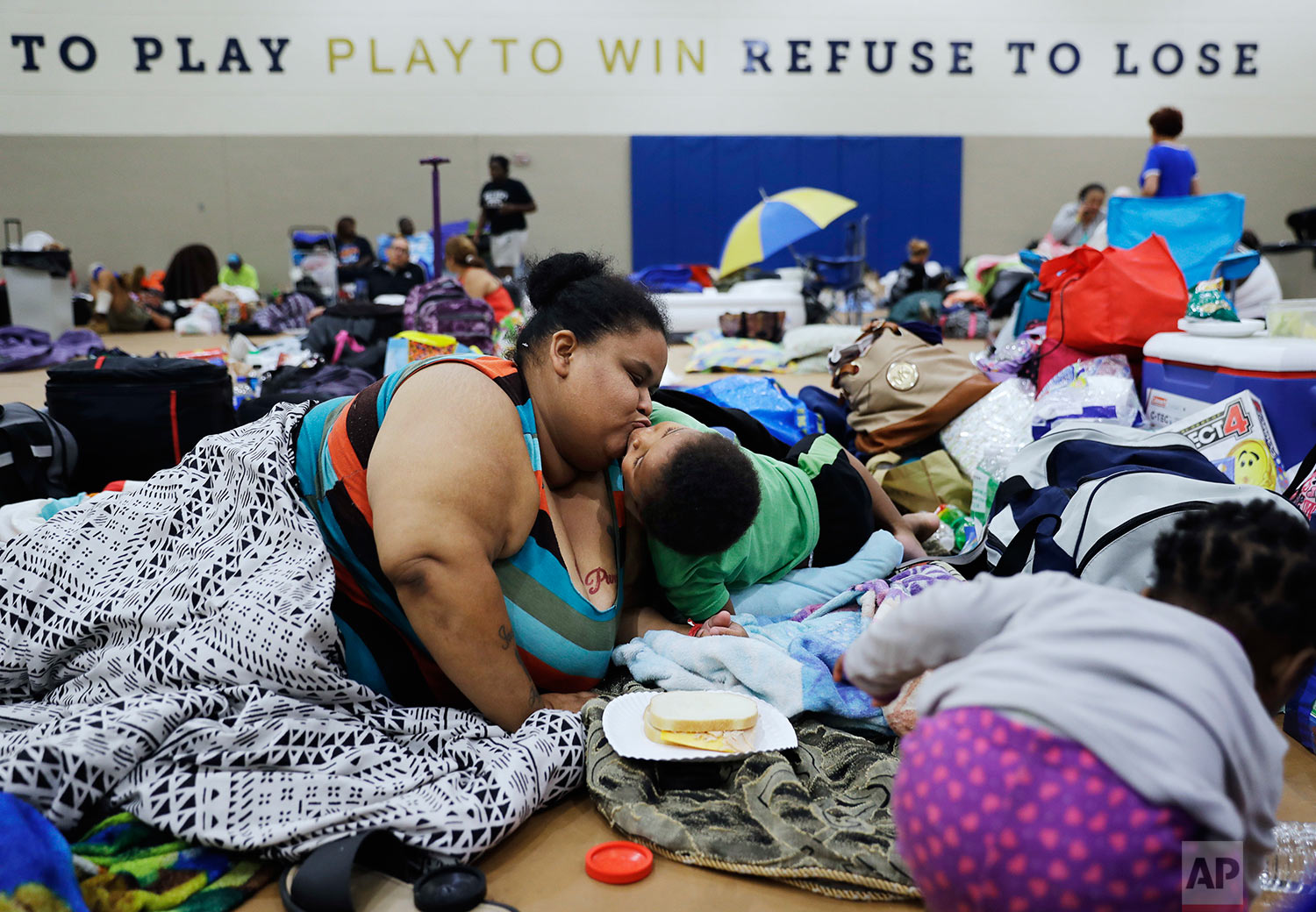  Annette Davis kisses her son Darius, 3, while staying at a shelter in Miami after evacuating from their home in Florida City, Fla., ahead of Hurricane Irma Saturday, Sept. 9, 2017. (AP Photo/David Goldman) 