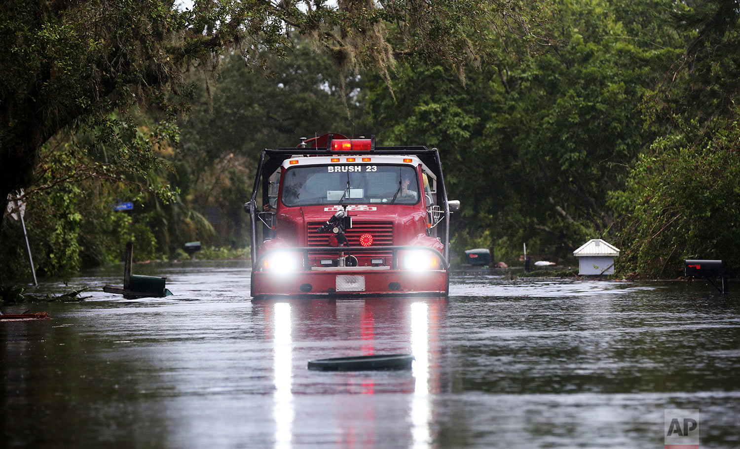  A fire truck drives through a flooded neighborhood, in the aftermath of Hurricane Irma, in Bonita Springs, Fla., Monday, Sept. 11, 2017. (AP Photo/Gerald Herbert) 