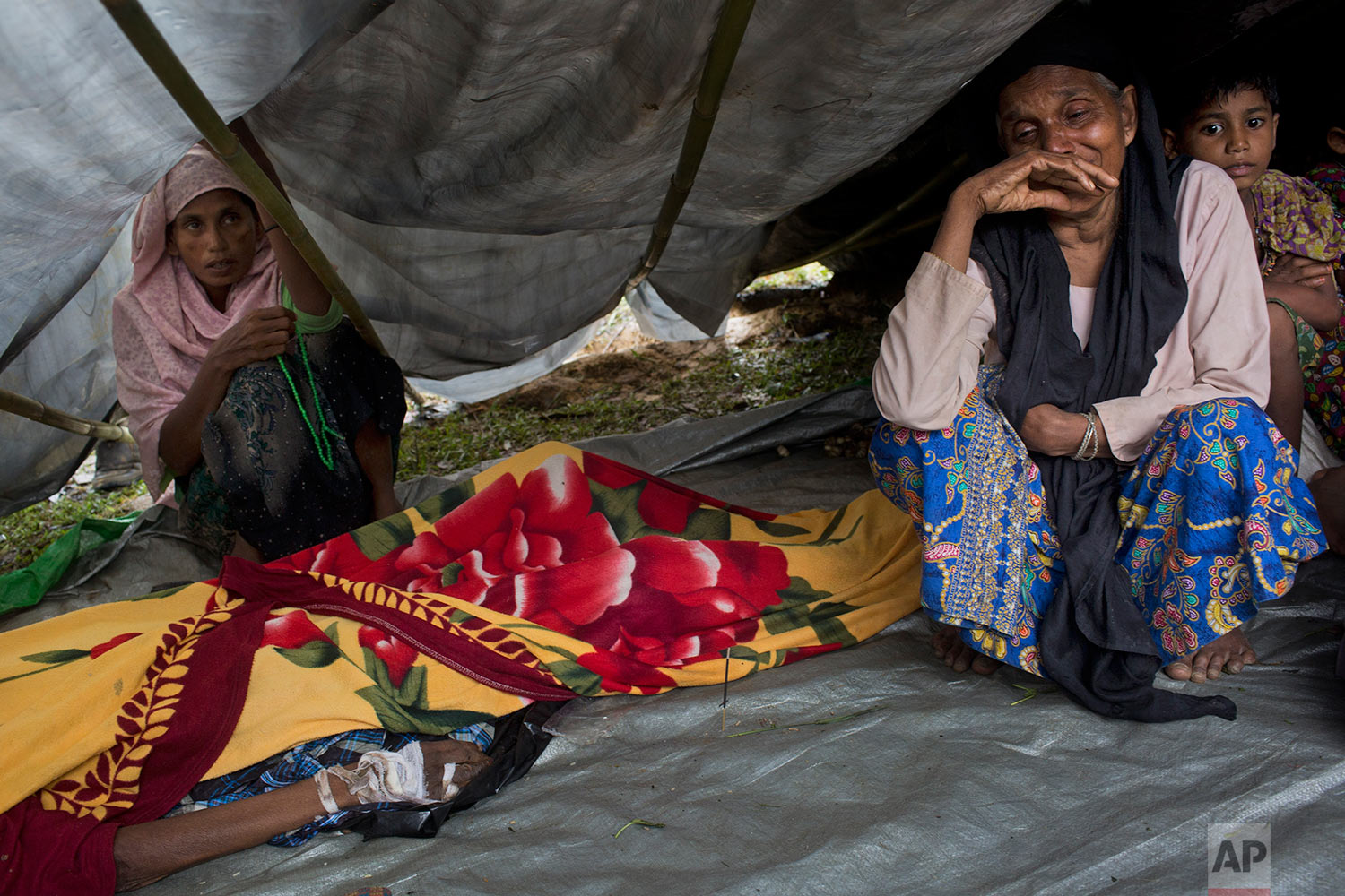  Newly arrived Rohingyas mourn by the body of a family member Ali Akbar, 70, in a makeshift tent in Kutupalong, Bangladesh, Friday, Sept. 8, 2017. According to family members, Akbar was shot in the hand and beaten with rifle butts by Myanmar soldiers