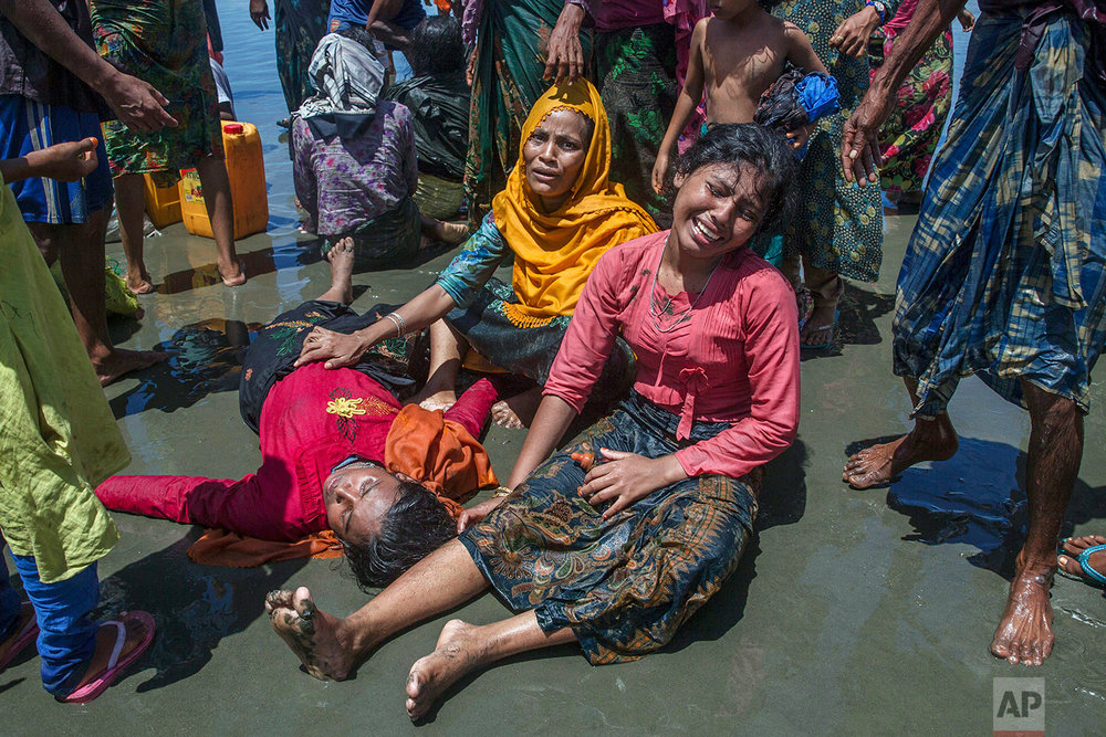  Rohingya Muslim women, who crossed over from Myanmar into Bangladesh, wail as a relative lies unconscious after the boat they were traveling in capsized minutes before reaching shore at Shah Porir Dwip, Bangladesh, Thursday, Sept. 14, 2017. The woma