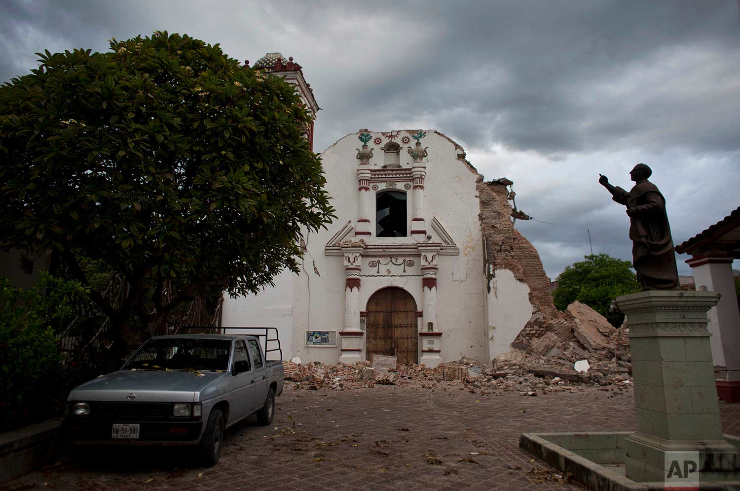 Clouds hover over the damaged San Vicente church on Sunday, Sept. 10, 2017 after an 8.1 magnitude earthquake the previous week in Juchitan, Oaxaca state, Mexico. In Juchitan, a third of the homes are reported uninhabitable and repeated aftershocks have scared people away from many structures still standing. (AP Photo/Rebecca Blackwell)