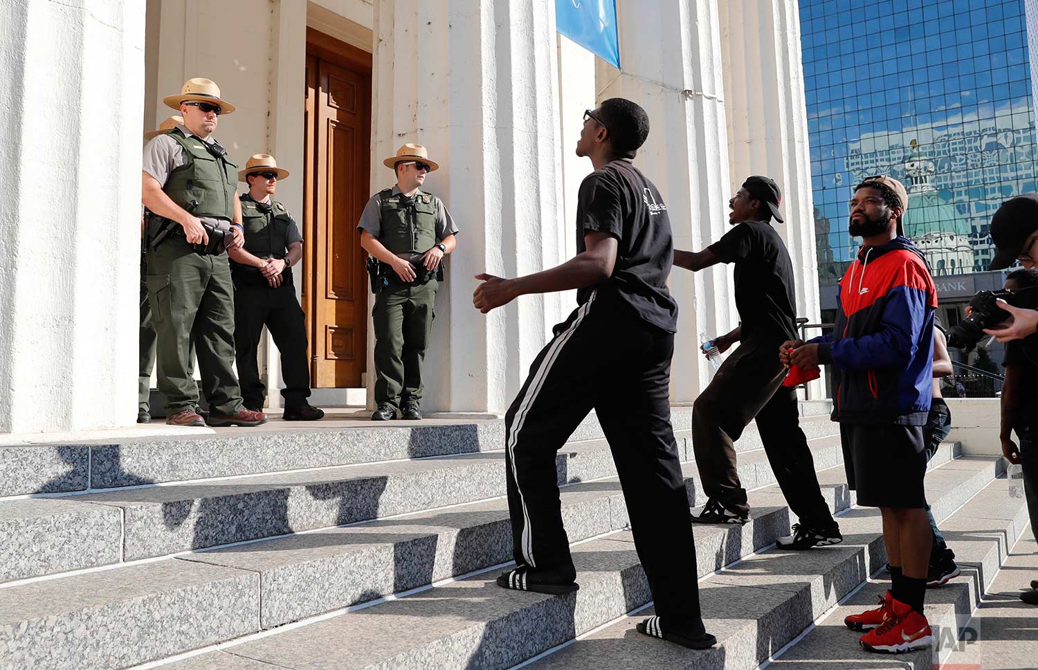 Protesters yell at National Park Service rangers on the steps of the Old Courthouse following a verdict in the trial of former St. Louis police officer Jason Stockley in St. Louis on Friday, Sept. 15, 2017. Stockley, a white police officer, was found not guilty in the 2011 killing of black suspect Lamar Smith following a high-speed chase. (AP Photo/Jeff Roberson)