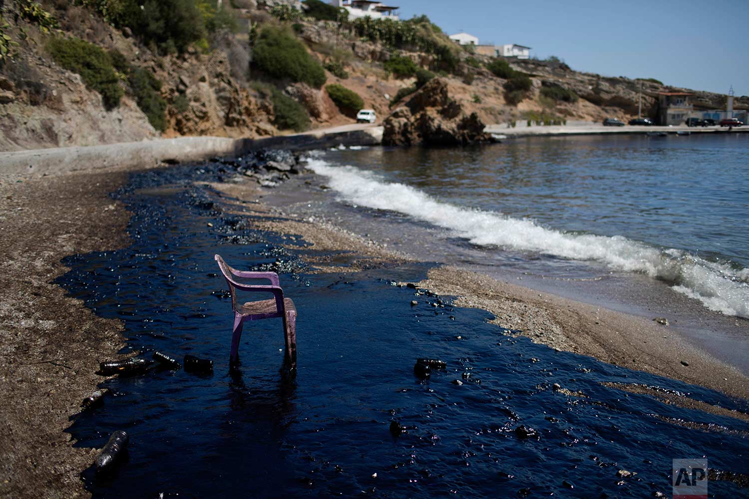  A plastic chair stands on a polluted beach after an oil spill on the island of Salamina, Greece, near Athens, on Tuesday, Sept. 12, 2017. Greece's merchant marine minister says clean-up crews are working to contain the damage caused after the small 