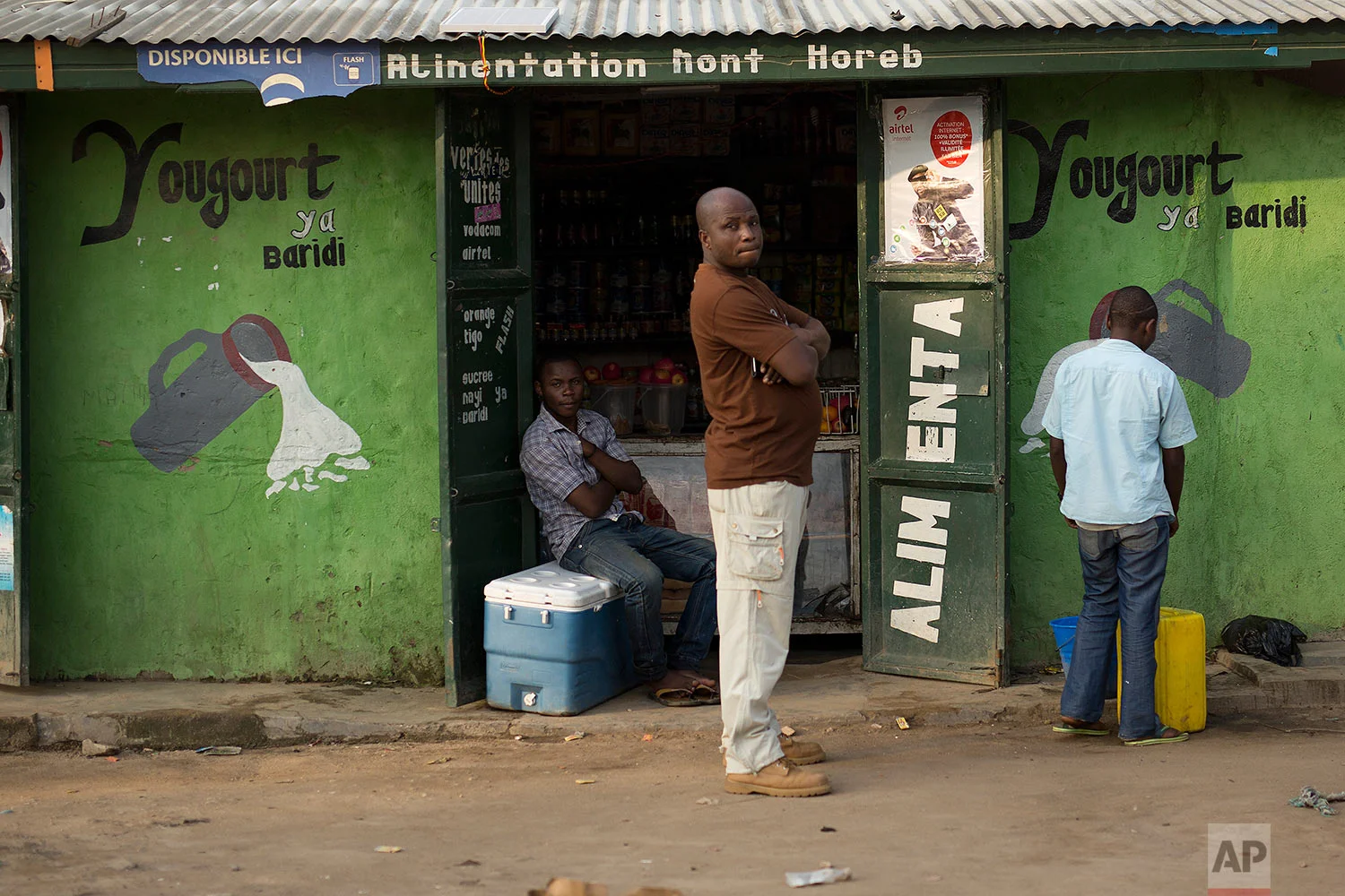 In this photo taken Aug. 10, 2016, a man stands at the entrance of a shop in the Congo Ituri province capital Bunia. (AP Photo/Jerome Delay)