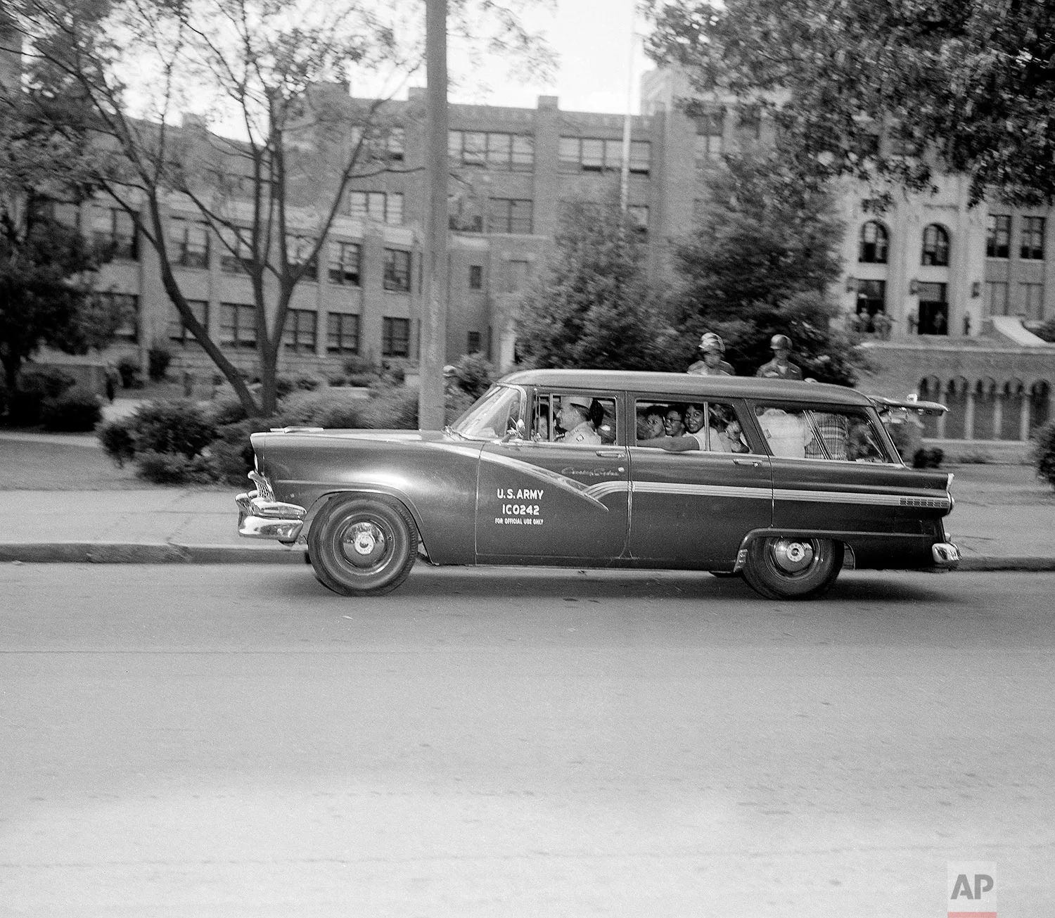 Ending their 10th day of integrated classes at Little Rock Central High School at Little Rock, Ark., nine black students are escorted by armed Guardsmen to a waiting Army station wagon, as school closed for the weekend, Oct. 4, 1957. (AP Photo/Richard Tolbert)