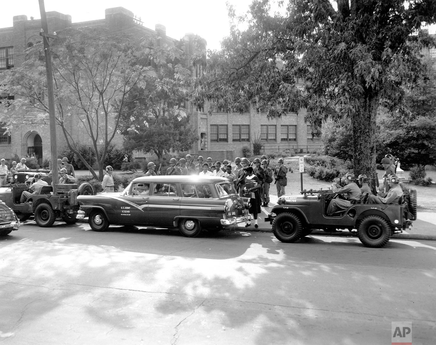 Federal troops escort black students as they enter Central High School in Little Rock, Ark., during the first week of student integration in Sept. 1957. (AP Photo)