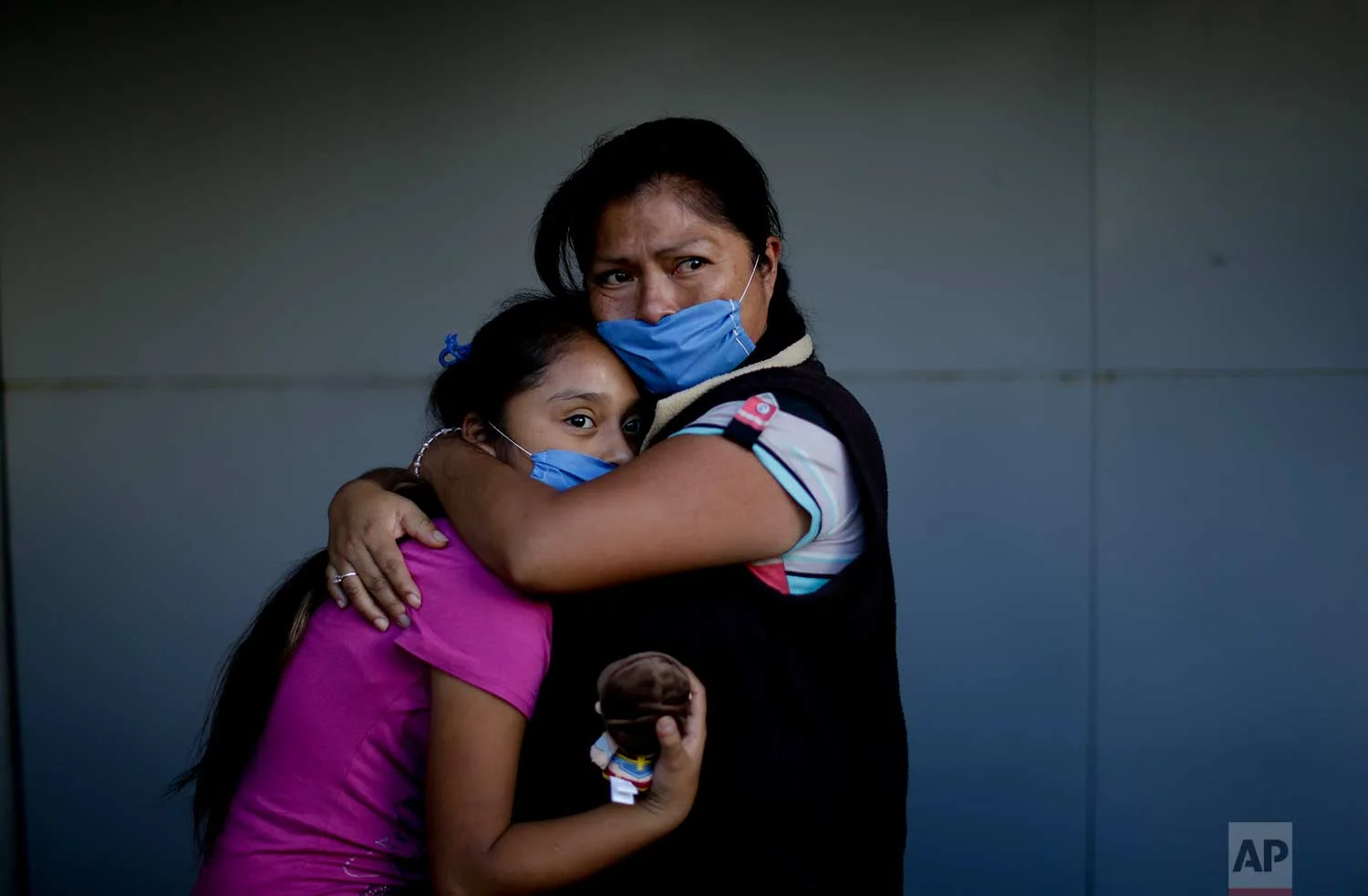Veronica Aguilar Naranjo embraces her 11-year-old daughter Veronica Villanueva as they look at a collapsed building where people search for survivors, Sept. 22, 2017, after an earthquake in Mexico City. (AP Photo/Natacha Pisarenko)