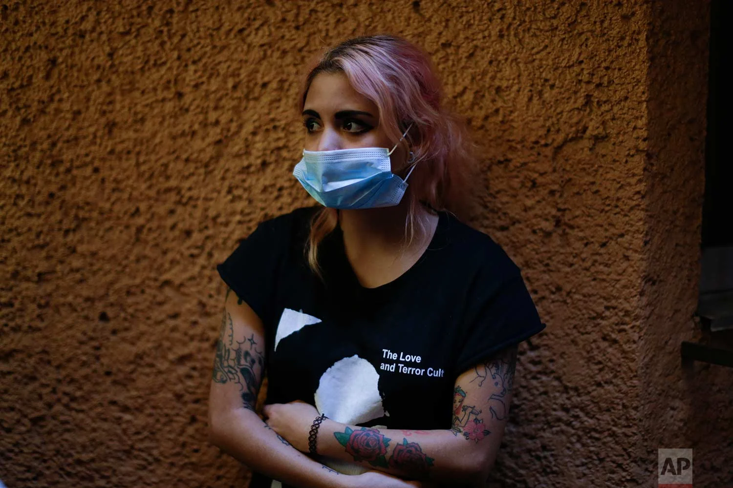 Luna Zetina poses for a portrait outside the building felled by an earthquake as she waits for news of her cousin, Sept. 22, 2017, in Mexico City, Mexico. Zetina is working to share first hand information with family members about Angel Javier Saucedo,27, who was inside the office building at the corner of Alvaro Obregon and Yucatan when the quake struck on Sept. 19. She said she also relays messages unrelated to her cousin to help overall communication efforts. (AP Photo/Natacha Pisarenko)