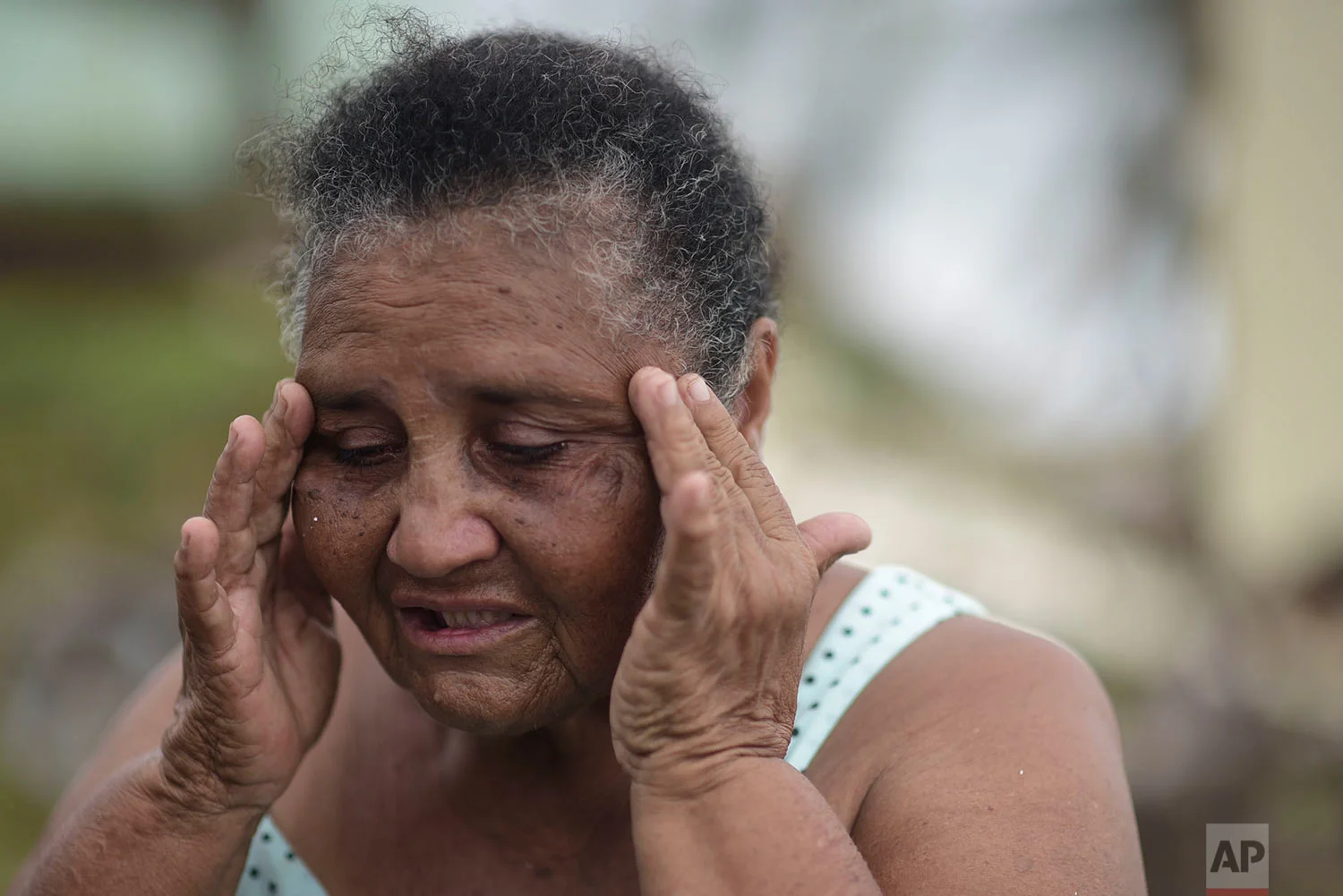El Negro community resident Irma Torres Rodriguez tries to stay calm after loosing a portion of her roof to the fury of Hurricane Maria, in Puerto Rico, Thursday, September 21, 2017.(AP Photo/Carlos Giusti)