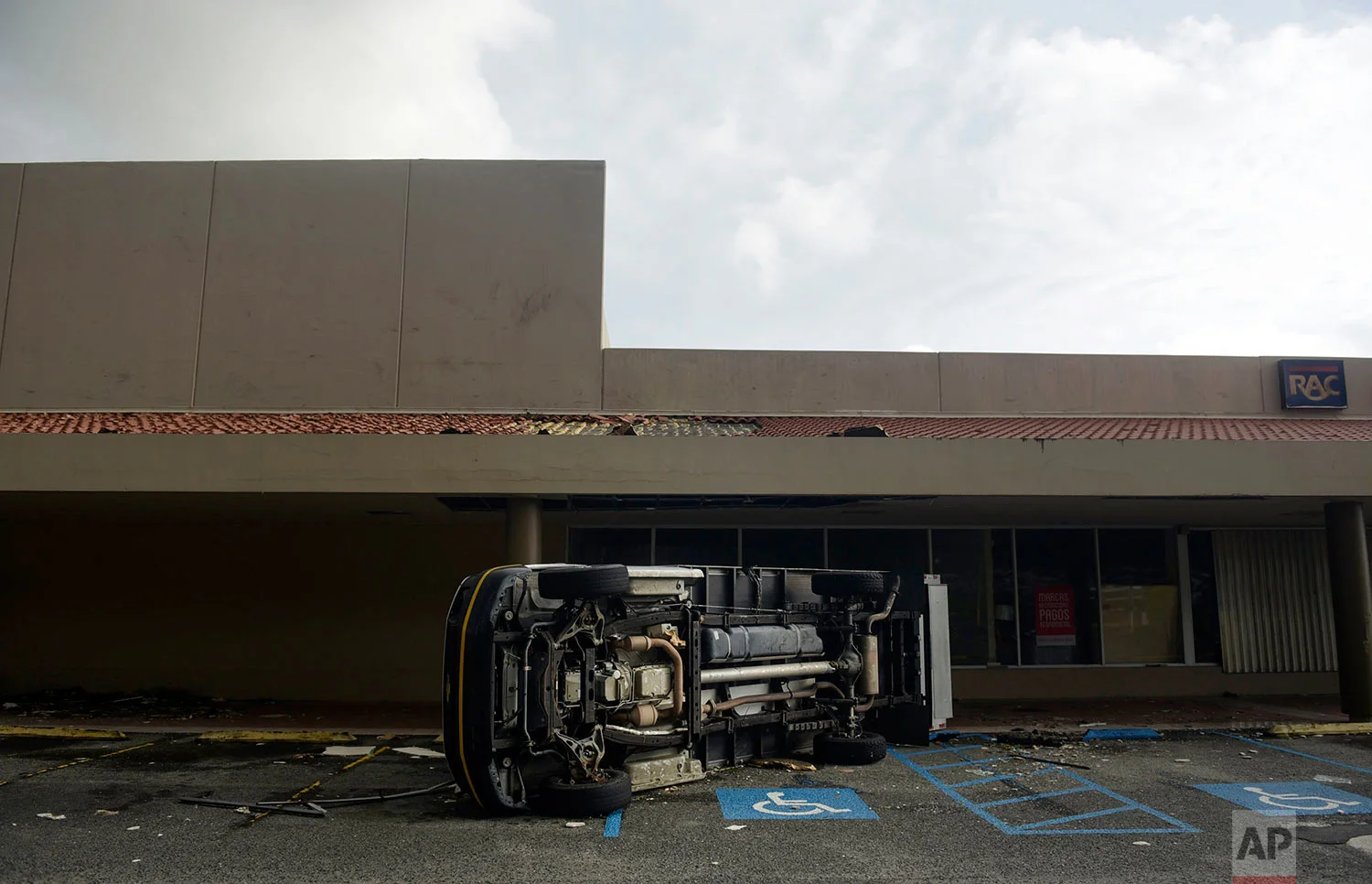 An overturned vehicle stands in a parking lot after the passing of Hurricane Maria, in Yabucoa, Puerto Rico, Thursday, September 21, 2017. (AP Photo/Carlos Giusti)