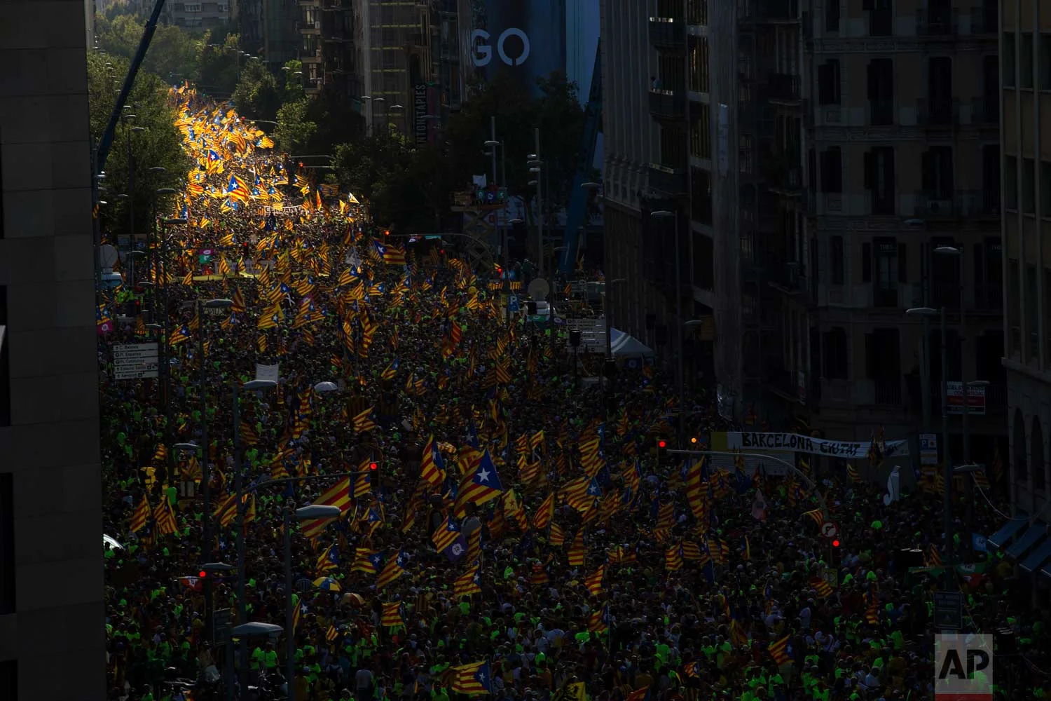 In this photo taken on Monday Sept. 11, 2017, people wave "estelada" or independence flags, during the Catalan National Day in Barcelona, Spain, Monday Sept. 11, 2017. (AP Photo/Emilio Morenatti)