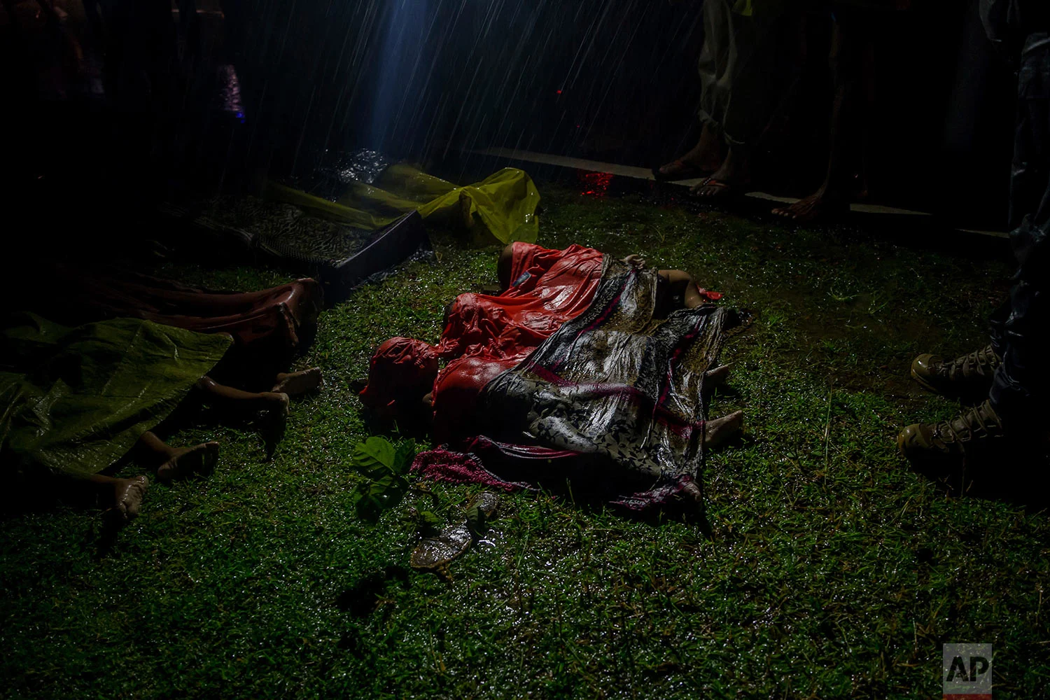 Bodies of Rohingya Muslim children, who died after their boat capsized in the Bay of Bengal as they were crossing over from Myanmar into Bangladesh, lies on a roadside near Inani beach, in Cox's Bazar district, Bangladesh, Thursday, Sept. 28, 2017. (AP Photo/Dar Yasin)