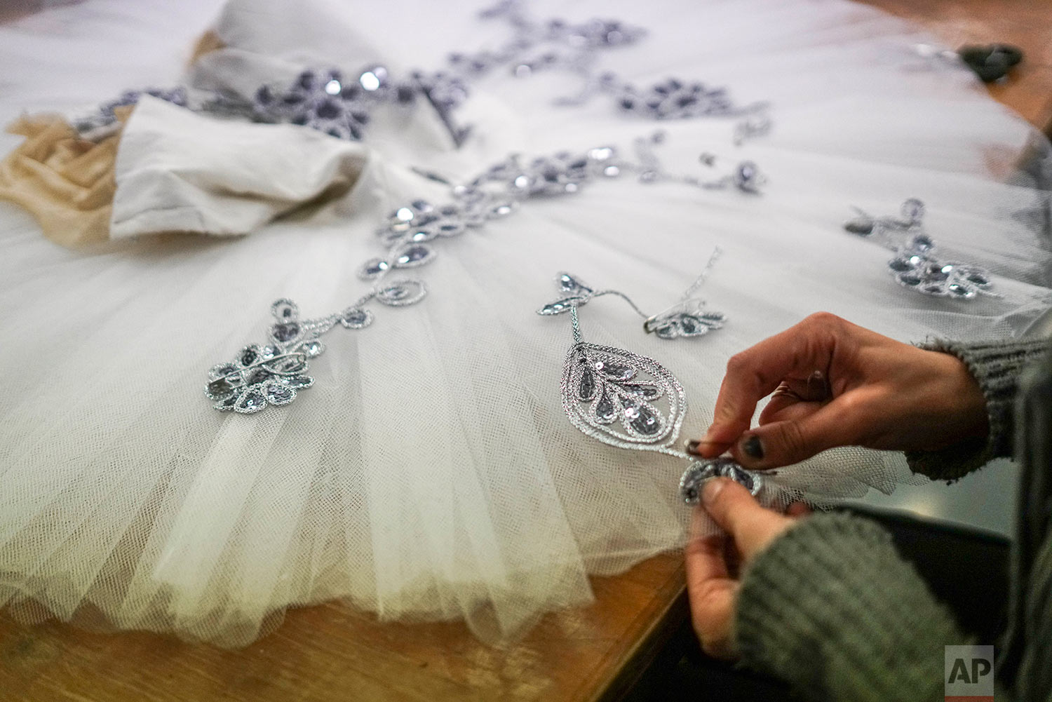  In this Friday, Sept. 15, 2017 photo, a seamstress sews a tutu for The Nutcracker production by Uruguay’s National ballet of the Sodre in Montevideo, Uruguay. (AP Photo/Matilde Campodonico) 