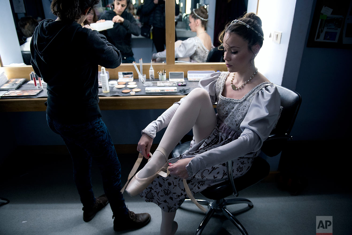  In this Friday, Sept. 15, 2017 photo, a dancer puts her ballet shoes on before a dress rehearsal for Romeo and Juliet in Montevideo, Uruguay. (AP Photo/Matilde Campodonico) 
