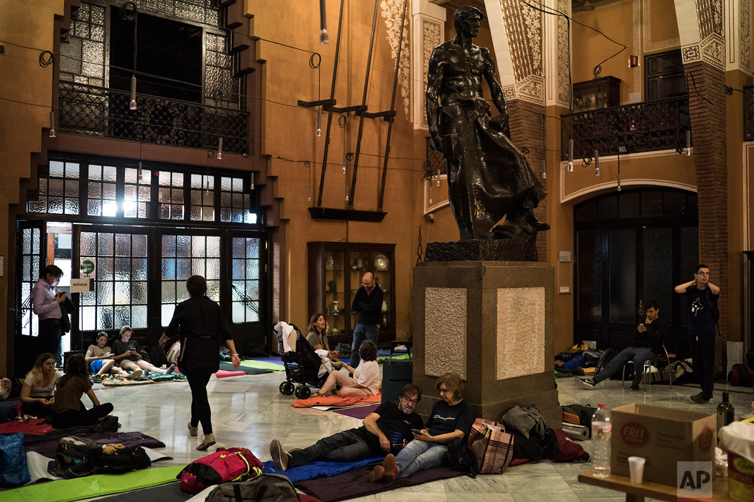  People prepare to spend the night inside a school listed to be a polling station by the Catalan government in Barcelona, Spain, Saturday, Sept. 30 2017. Catalan pro-referendum residents vowed Saturday to ignore a police ultimatum to leave the school