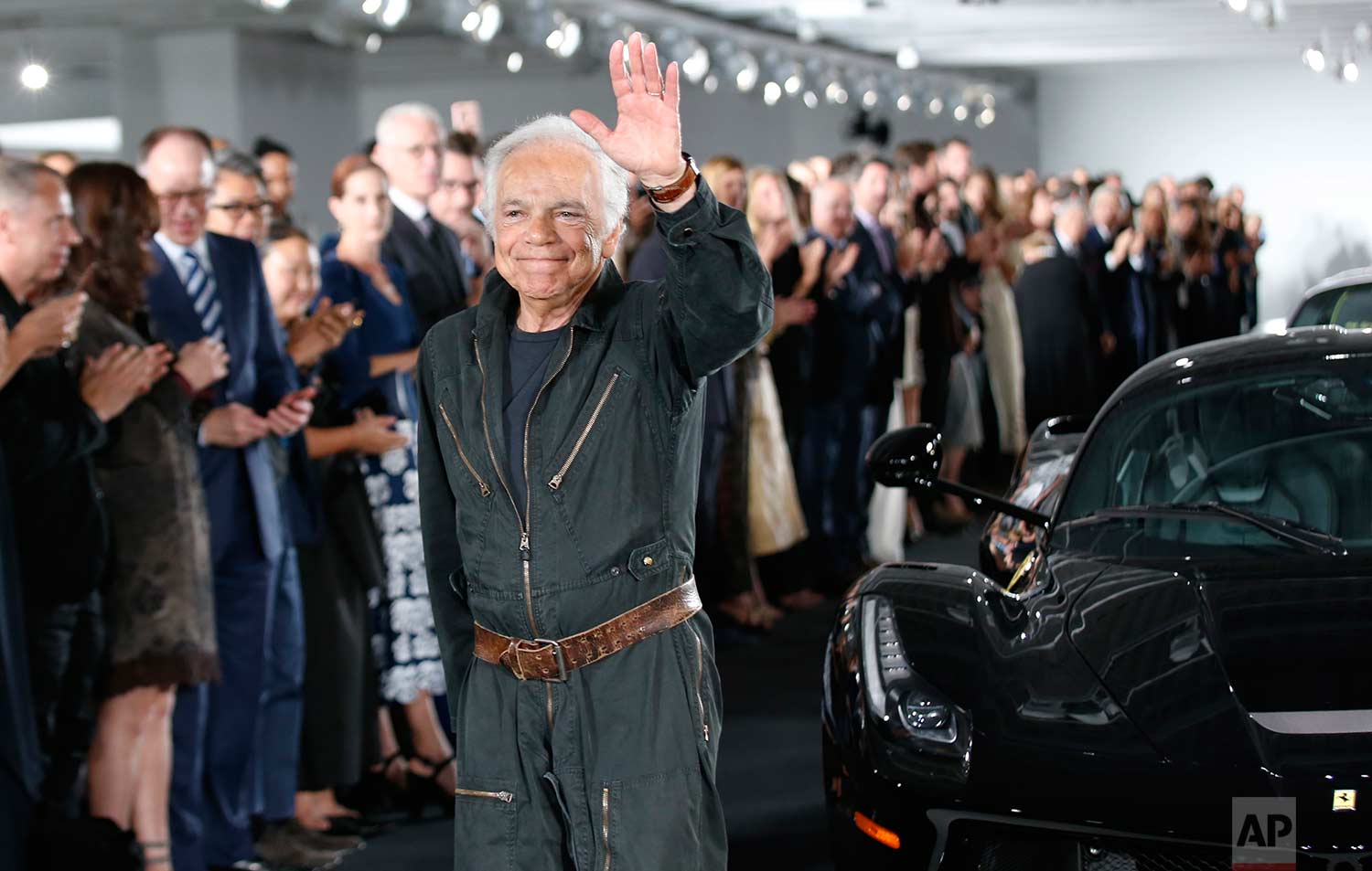  Ralph Lauren waves beside one car from his collection in The Garage at the conclusion of the Ralph Lauren fashion show during Fashion Week, Tuesday, Sept. 12, 2017, in Bedford, NY. (AP Photo/Kathy Willens) 