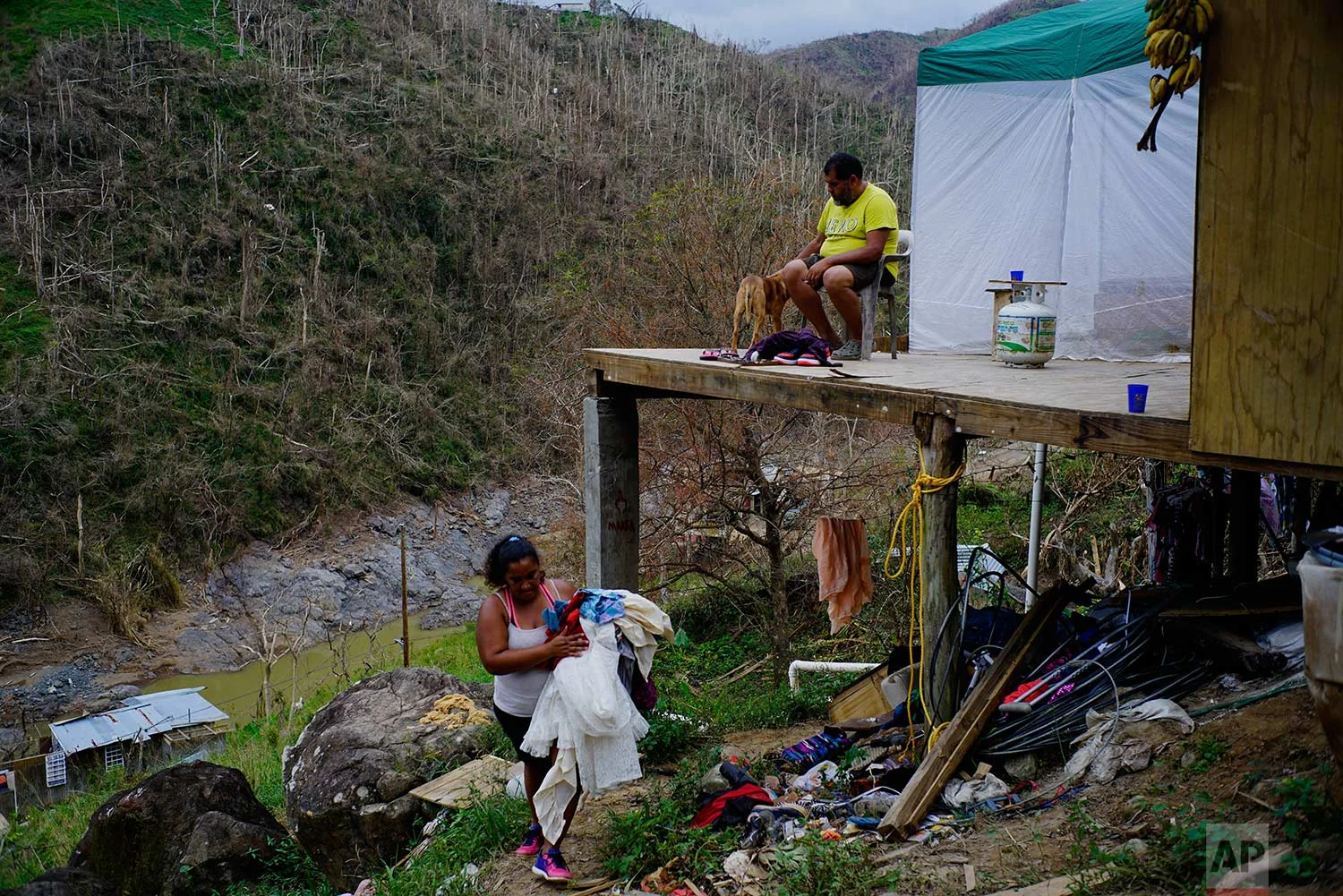 Yadira Sortre and William Fontan Quintero clean their house, destroyed by Hurricane Maria in in Morovis, Puerto Rico, Sunday, Oct. 1, 2017. (AP Photo/Ramon Espinosa)