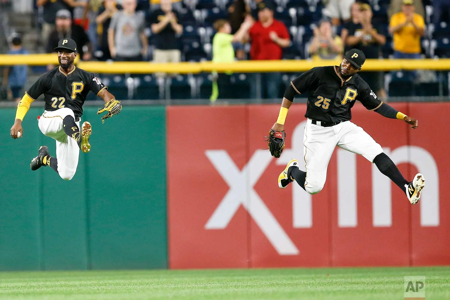 Pittsburgh Pirates center fielder Andrew McCutchen (22) and right fielder Gregory Polanco (25) leap in celebration after the Pirates defeated the Baltimore Orioles 5-3 in a baseball game, Wednesday, Sept. 27, 2017, in Pittsburgh. (AP Photo/Keith Srakocic)