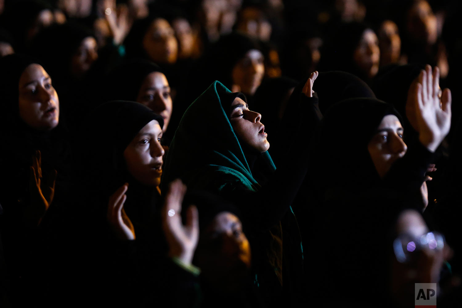 Hezbollah supporters listen to the story of Imam Hussein during activities to mark the ninth of Ashoura, a 10-day ritual commemorating the death of Imam Hussein, in a southern suburb of Beirut, Lebanon, Saturday, Sept. 30, 2017. (AP Photo/Hassan Ammar)