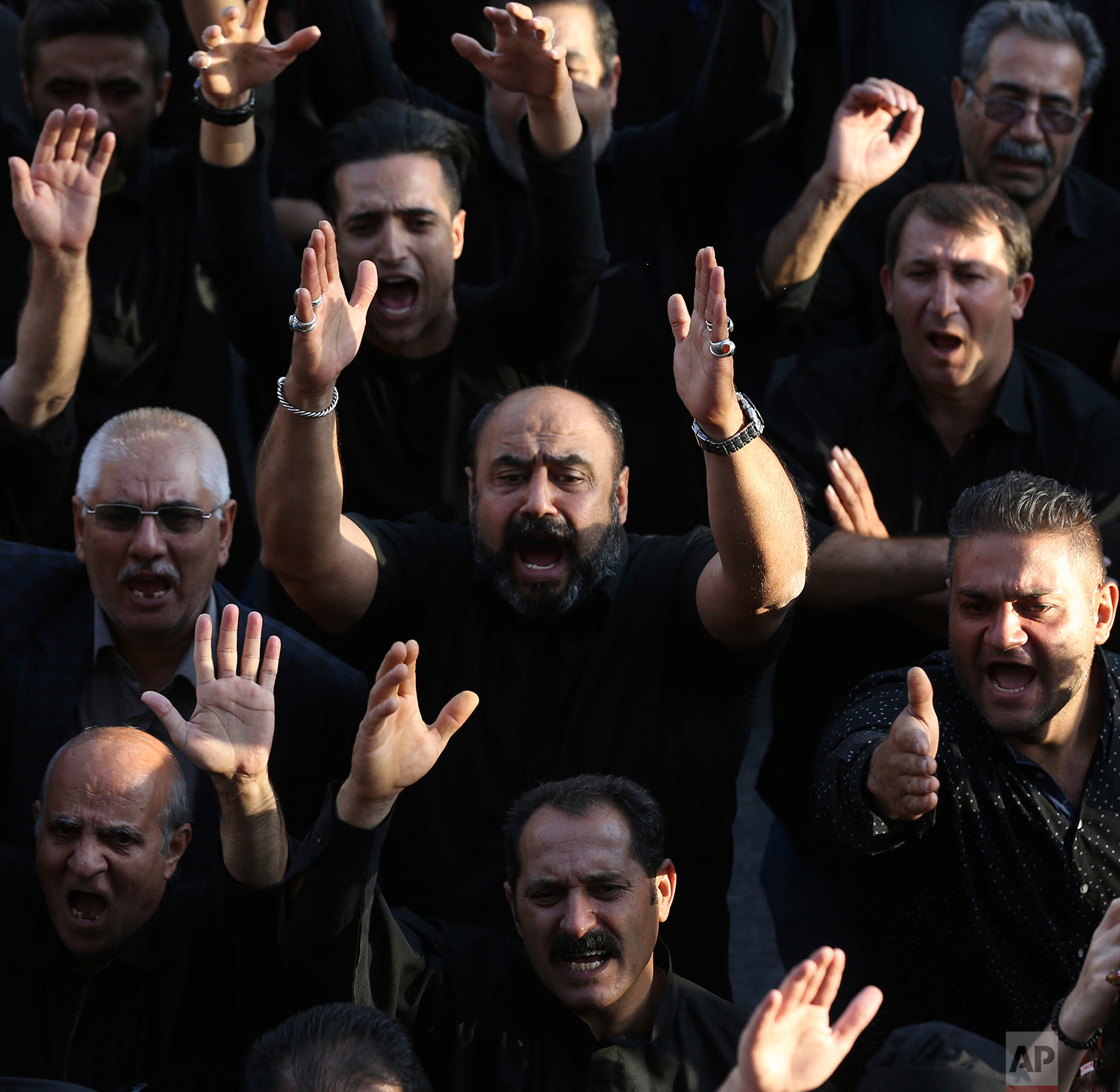 Mourners take part in a procession during the Muslim month of Muharram, an important period of mourning for Muslim Shiites which marks the anniversary of martyrdom of Imam Hussein, a grandson of Prophet Muhammad and the third Shiite saint, who was killed during a battle in Karbala in present-day Iraq in 7th century, in Tehran, Iran, Friday, Sept. 29, 2017. (AP Photo/Vahid Salemi)