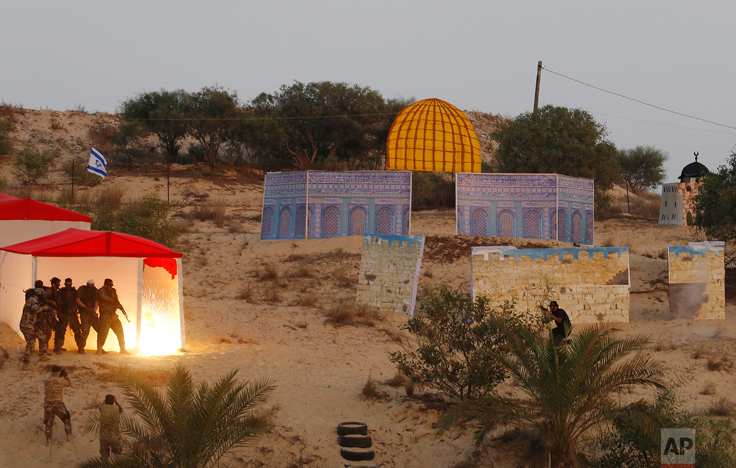  Masked militants from the al-Nasser Brigades, an armed wing of the Popular Resistance Committees (PRC), attend a military drill simulating an attack on an Israeli Jewish settlement around the Dome of the rock, at their training camp in Khan Younis, 