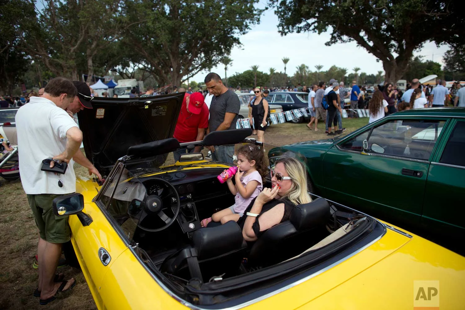 People look at antique cars during the 31st annual "Five Club" collectors car meeting in Ramat Gan, Israel, Friday, Oct. 6, 2017. (AP Photo/Oded Balilty)