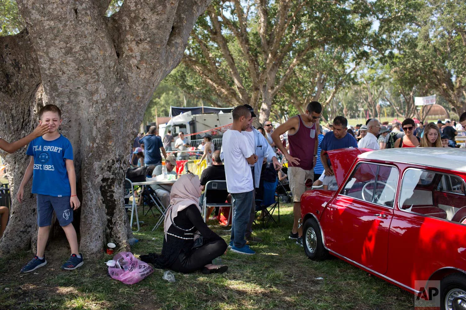 People look at antique cars during the 31st Annual "Five Club" car collectors' meeting in Ramat Gan, Israel, Friday, Oct. 6, 2017. (AP Photo/Oded Balilty)