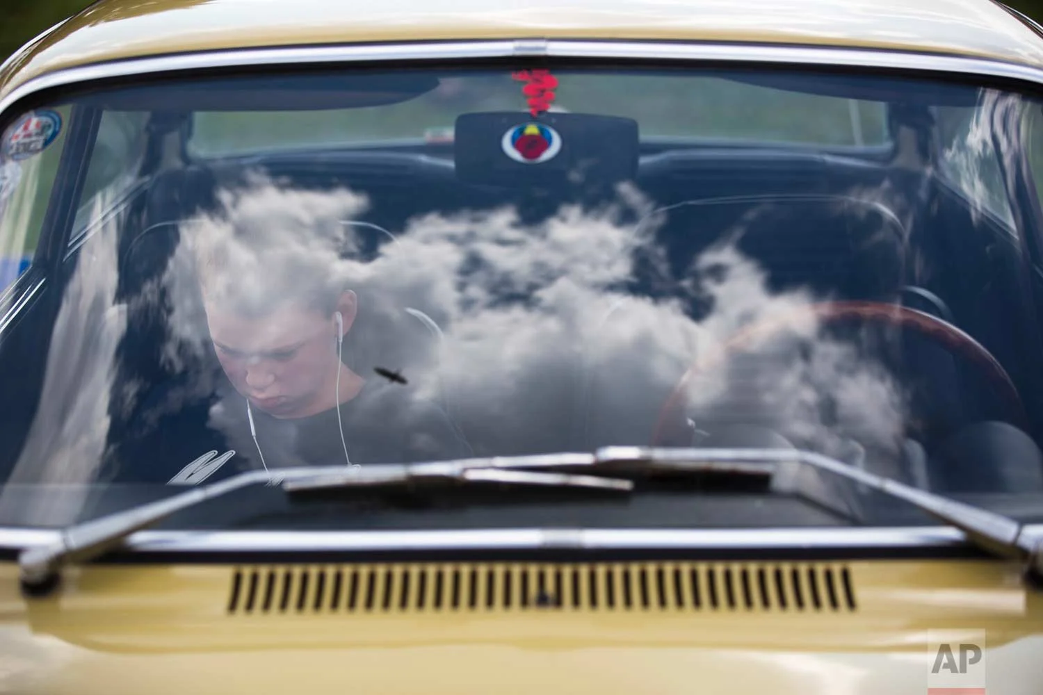 A youth sits in his grandfather antique car during the 31st annual "Five Club" car collectors' meeting in Ramat Gan, Israel, Friday, Oct. 6, 2017. (AP Photo/Oded Balilty)