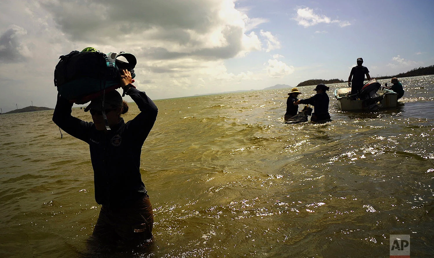 In this screen grab made from video on Wednesday, Oct. 4, 2017, scientists return to land from Cayo Santiago, known as Monkey Island, in Puerto Rico, one of the world’s most important sites for research into how primates think, socialize and evolve. (AP Photo/Ramon Espinosa)