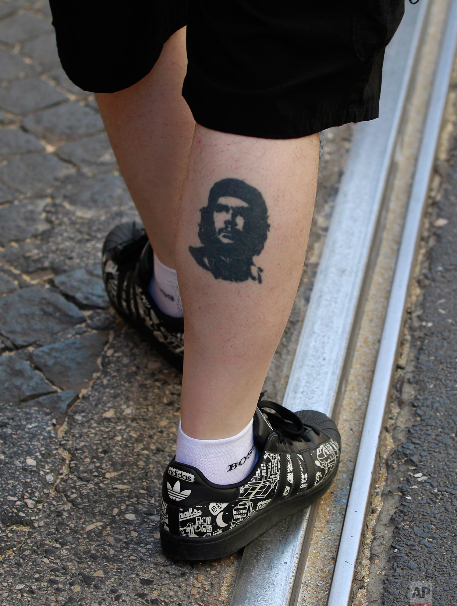  A protestor wearing a tattoo of Cuba's revolution leader Ernesto "Che" Guevara takes part in a demonstration in Lisbon against the government's plans of making it easier to lay-off people Thursday, July 28 2011. (AP Photo/Armando Franca) 
