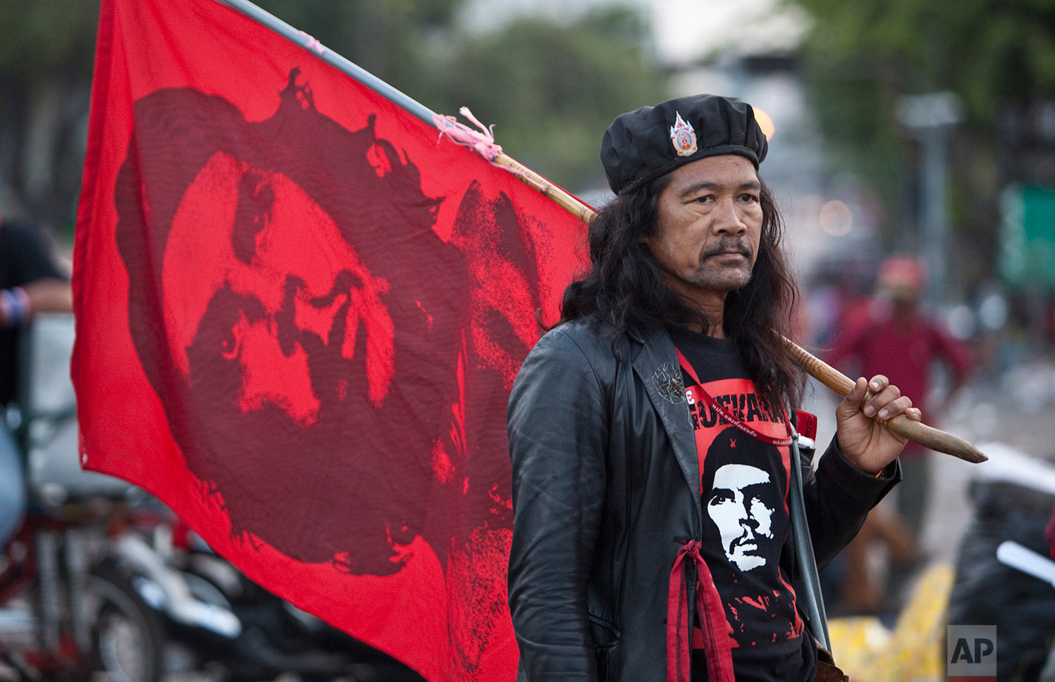  A "Red Shirt" demonstrator carries a flag of Cuban revolutionary Che Guevara as he and others wait to donate blood Tuesday, March 16, 2010, at an anti-government rally in Bangkok, Thailand. (AP Photo/David Longstreath) 