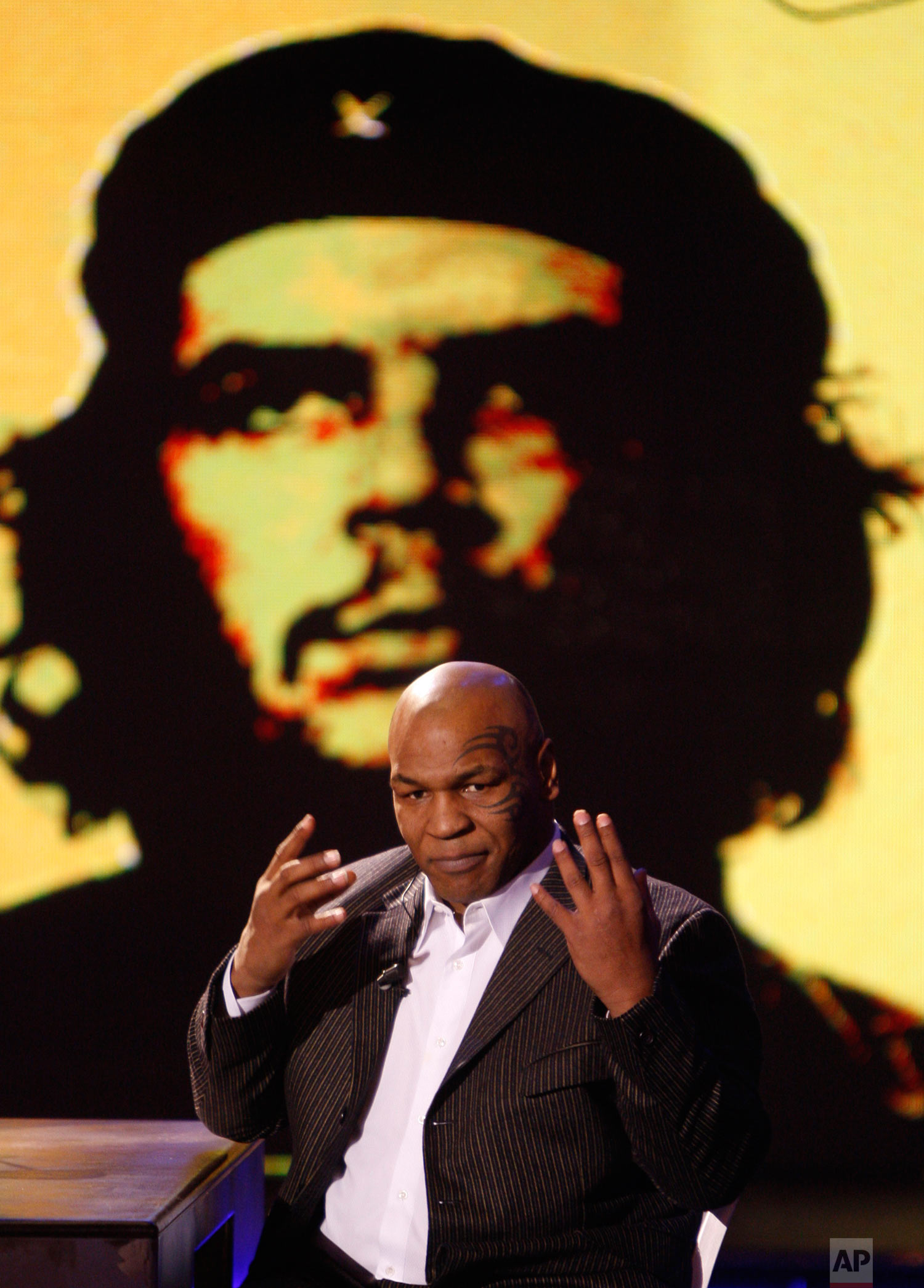  Former heavyweight boxing champion Mike Tyson reacts as a picture of Che Guevara is projected on a giant screen, during the taping of the "Chiambretti Night" television show in Milan, Italy, Monday, Jan. 25, 2010. (AP Photo/Luca Bruno) 