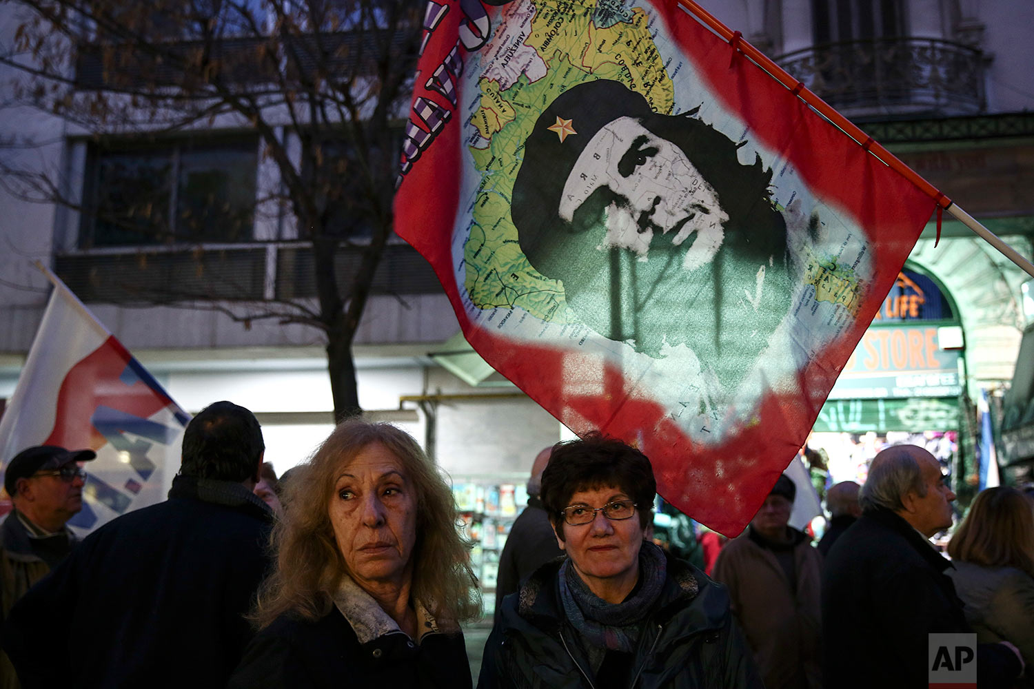  Supporters of the communist-affiliated union PAME stand beneath a flag depicting Cuban revolutionary leader Che Guevara during an anti-austerity rally in Athens, Tuesday, Feb. 21, 2017. (AP Photo/Yorgos Karahalis) 
