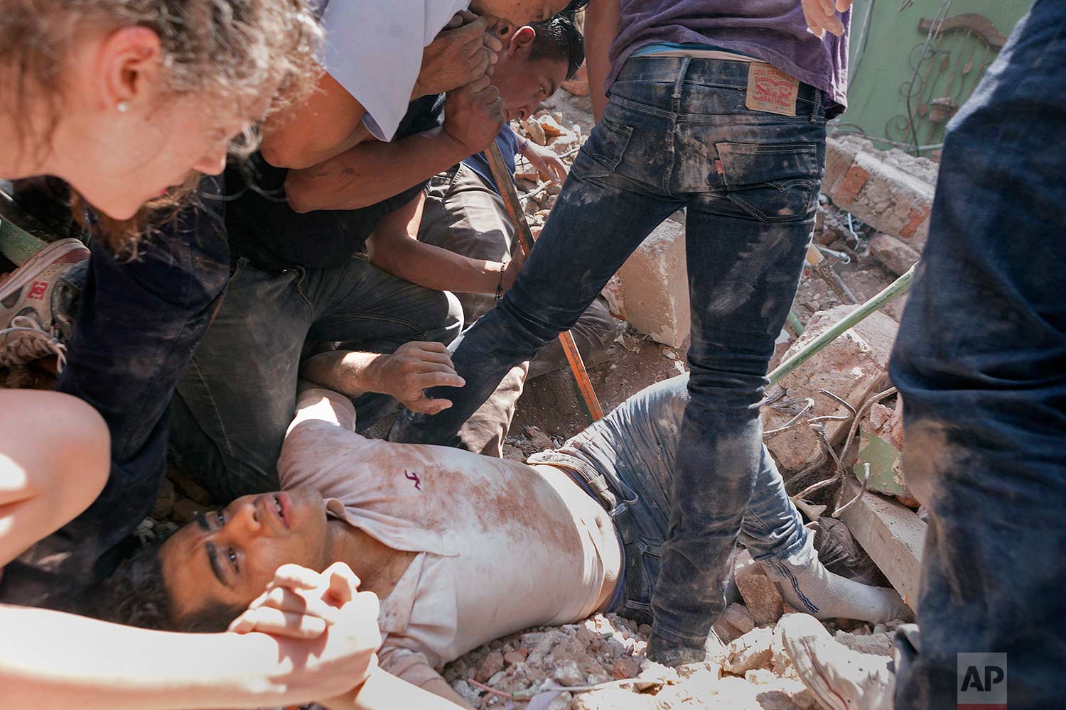 In this Sept. 19, 2017 photo, a man is rescued from a collapsed building in the Condesa neighborhood after an earthquake struck Mexico City. (AP Photo/Pablo Ramos)