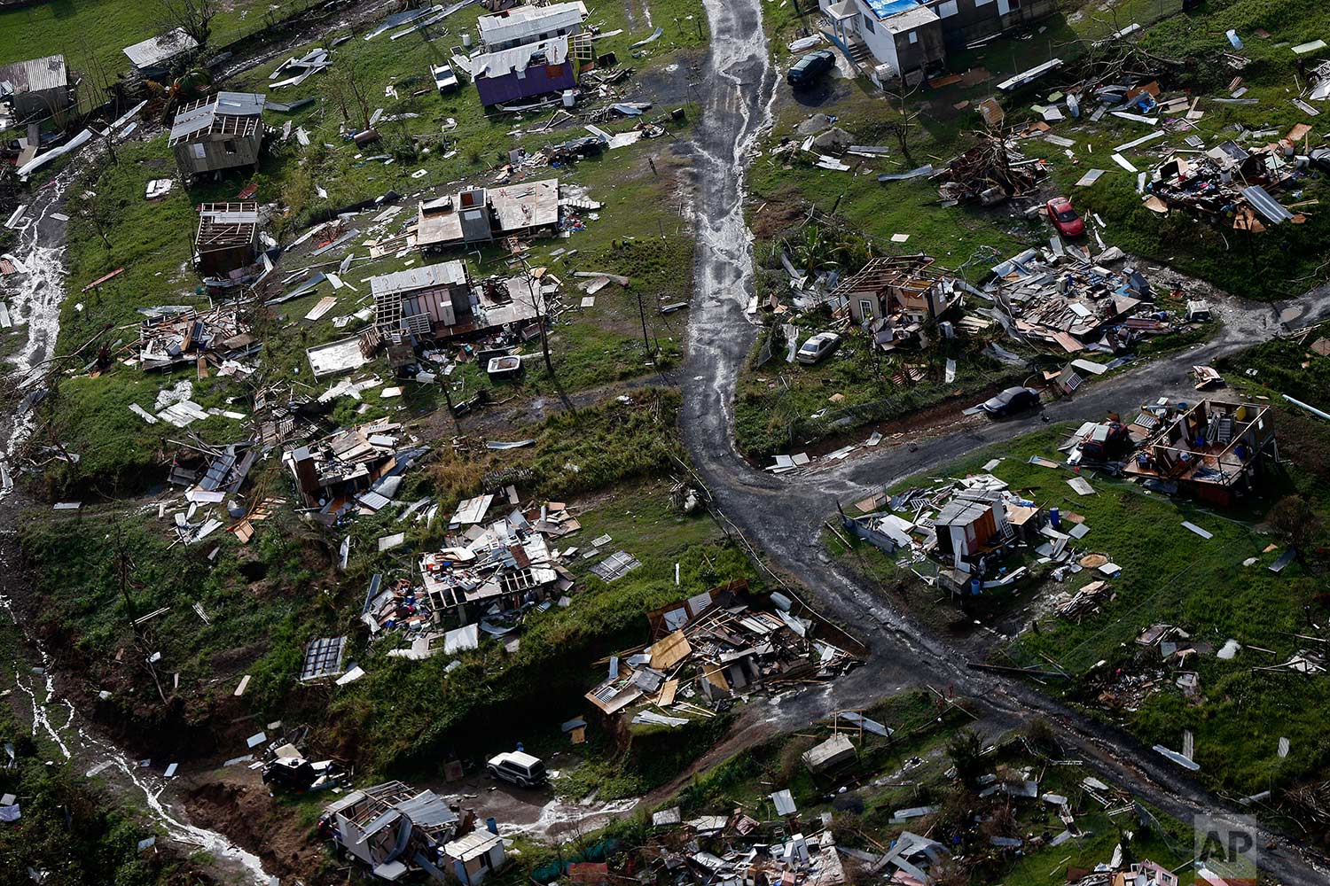 Destroyed communities are seen in the aftermath of Hurricane Maria in Toa Alta, Puerto Rico, Thursday, Sept. 28, 2017. (AP Photo/Gerald Herbert)