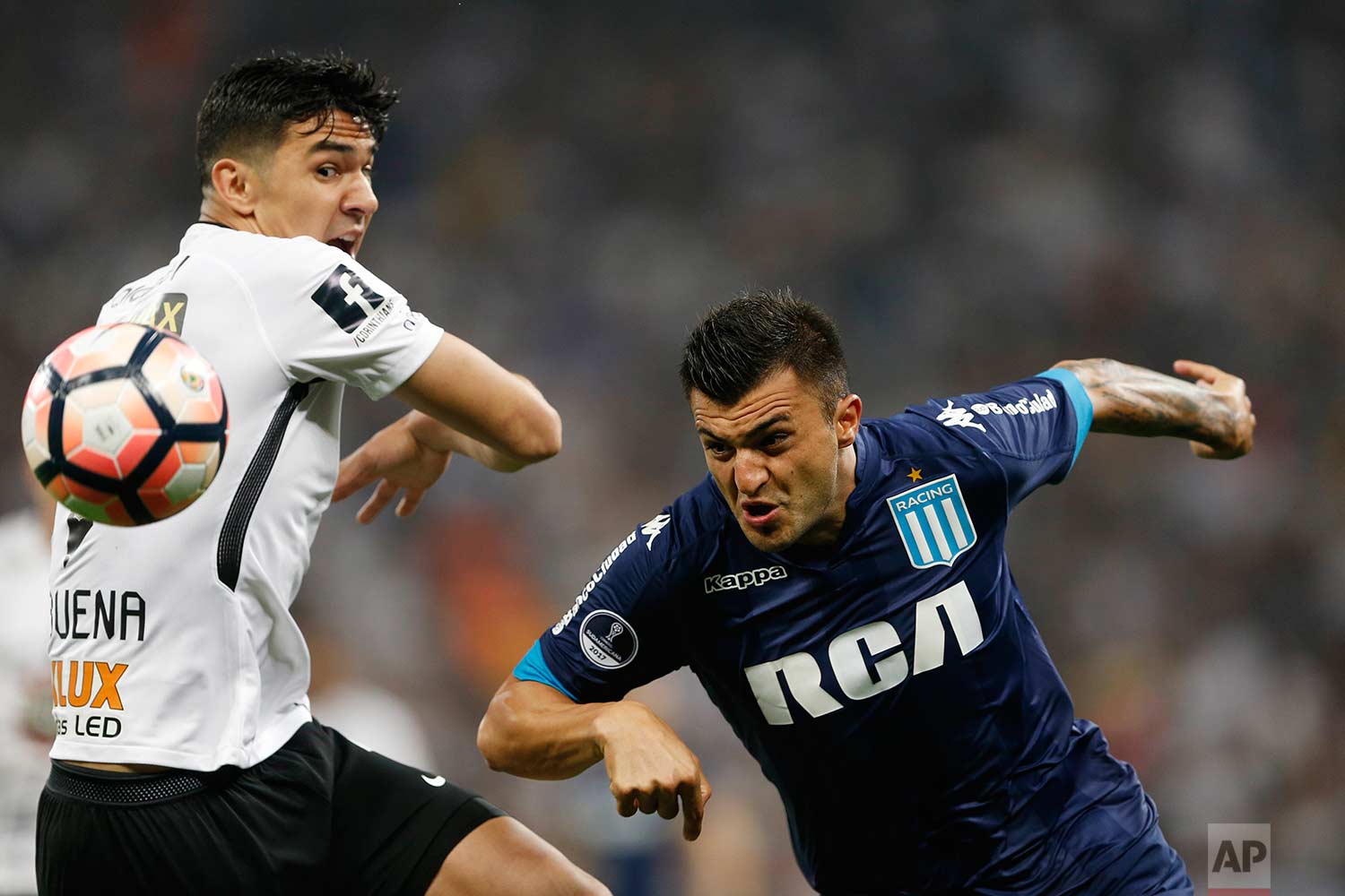 Fabian Balbuena of Brazil's Corinthians fights for the ball with Enrique Luis Triverio of Argentina's Racing Club, right, during a Copa Sudamericana soccer match in Sao Paulo, Brazil, Wednesday, Sept. 13, 2017. (AP Photo/Nelson Antoine)