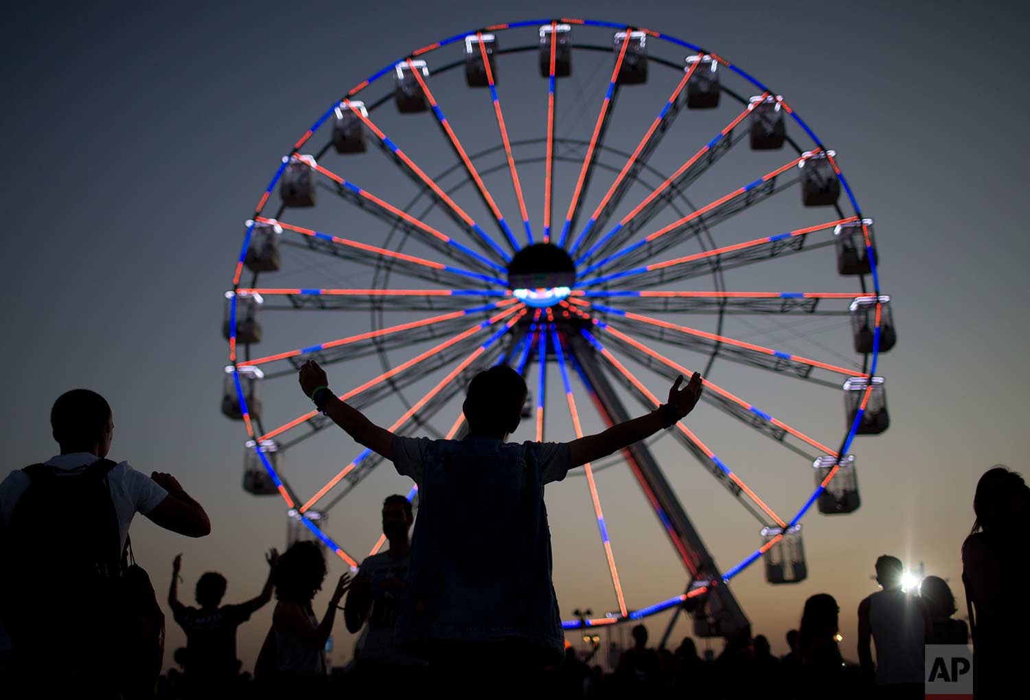 Fans attend the Rock in Rio music festival in Rio de Janeiro, Brazil, Thursday, Sept. 21, 2017. (AP Photo/Silvia Izquierdo)