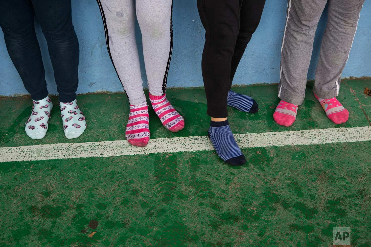 In this Aug. 25, 2017 photo, female nursing students stand in their socks as they take a self-defense workshop led by Muay Thai practitioners in Nezahualcoyotl, Mexico state. (AP Photo/Rebecca Blackwell)
