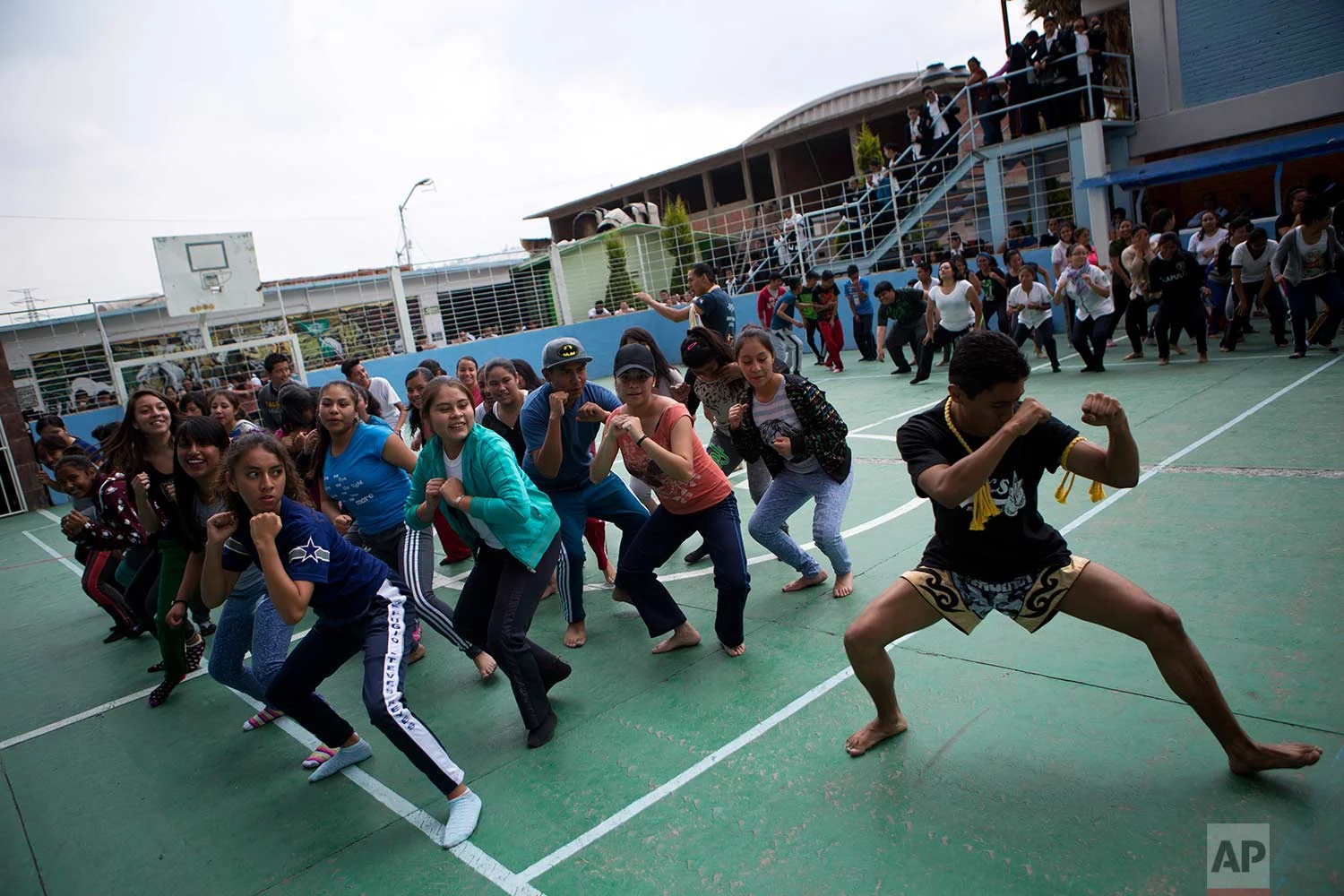 In this Aug. 25, 2017 photo, Muay Thai practitioners lead mostly female students at a nursing school in a self-defense workshop in Nezahualcoyotl, Mexico state.(AP Photo/Rebecca Blackwell)